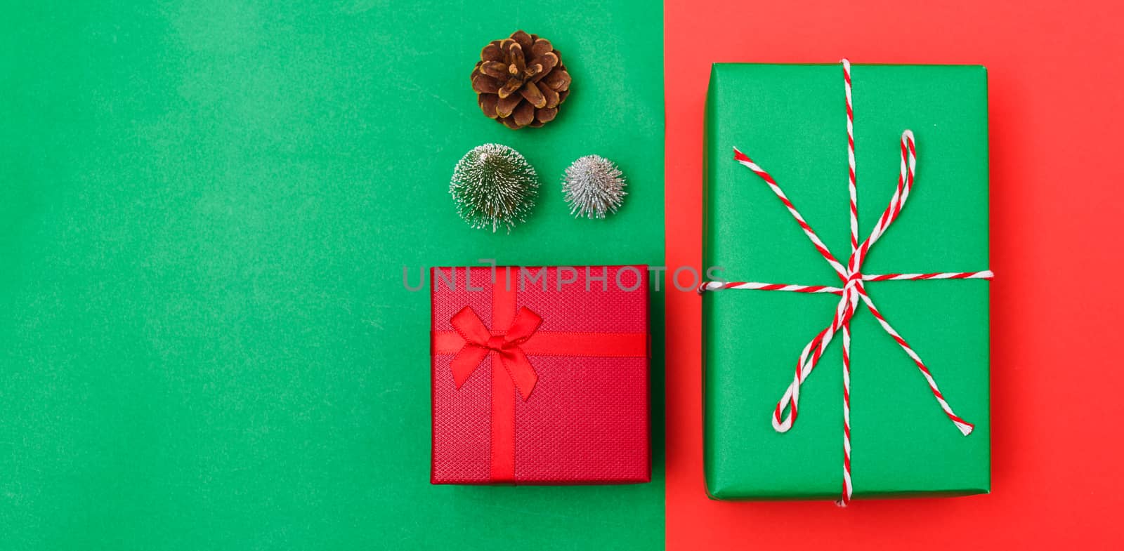 New Year, Christmas Xmas holiday composition, Top view with gift box, clews of rope, green fir tree branch on red and green background with copy space