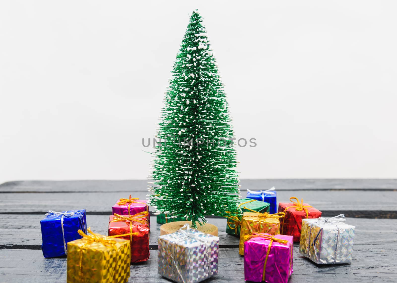 Christmas composition decorations, minimal green fir tree branches with snow and gift boxs on white background. Merry Christmas concept. Copy space for text