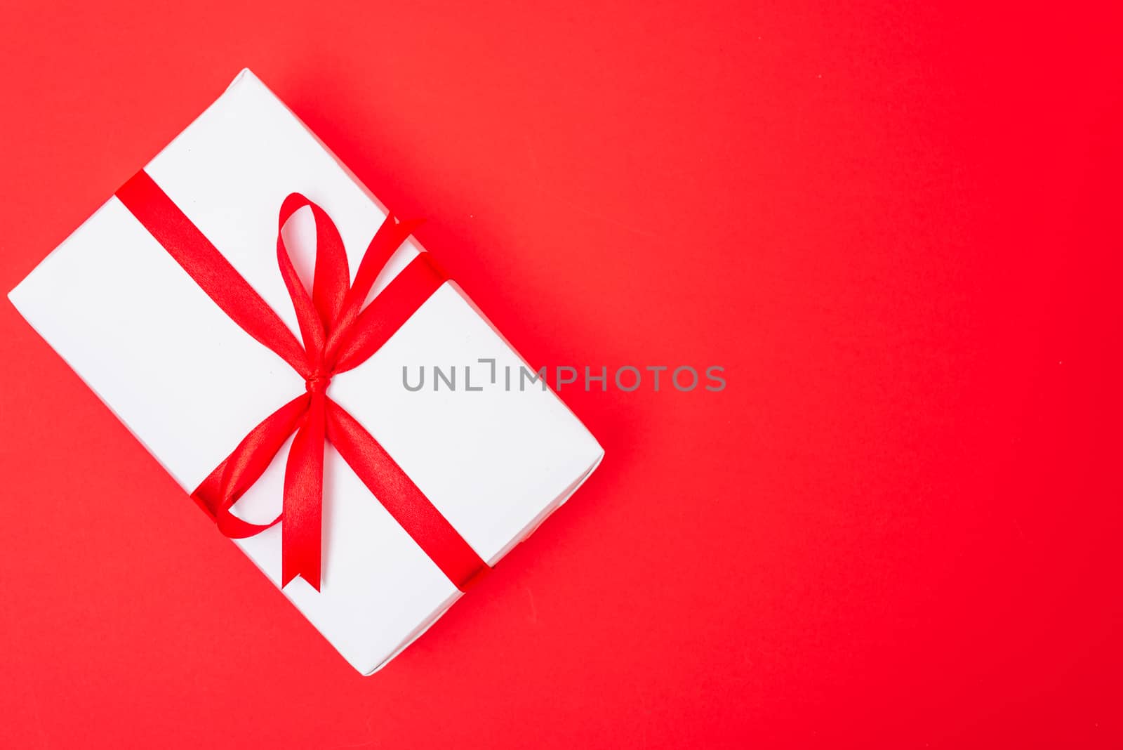 Happy New Year and Christmas 2020 or valentine day, top view Xmas white gift box on red background with copy space for your text