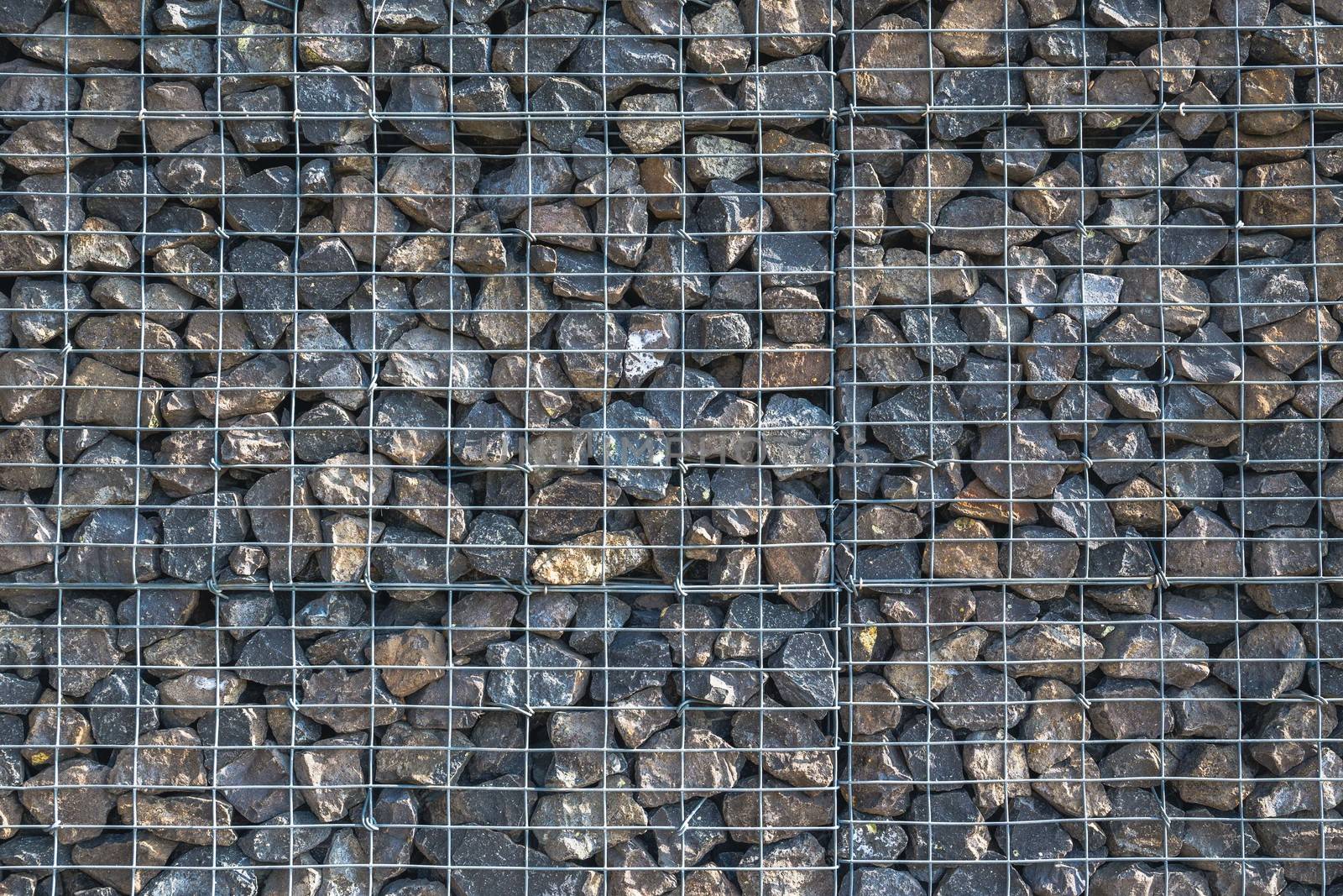 Wire Gabion Rock Fence. Metal Cage filled with rocks. Texture background of rock fence with cage. Nicely lit useful backgroud. by petrsvoboda91