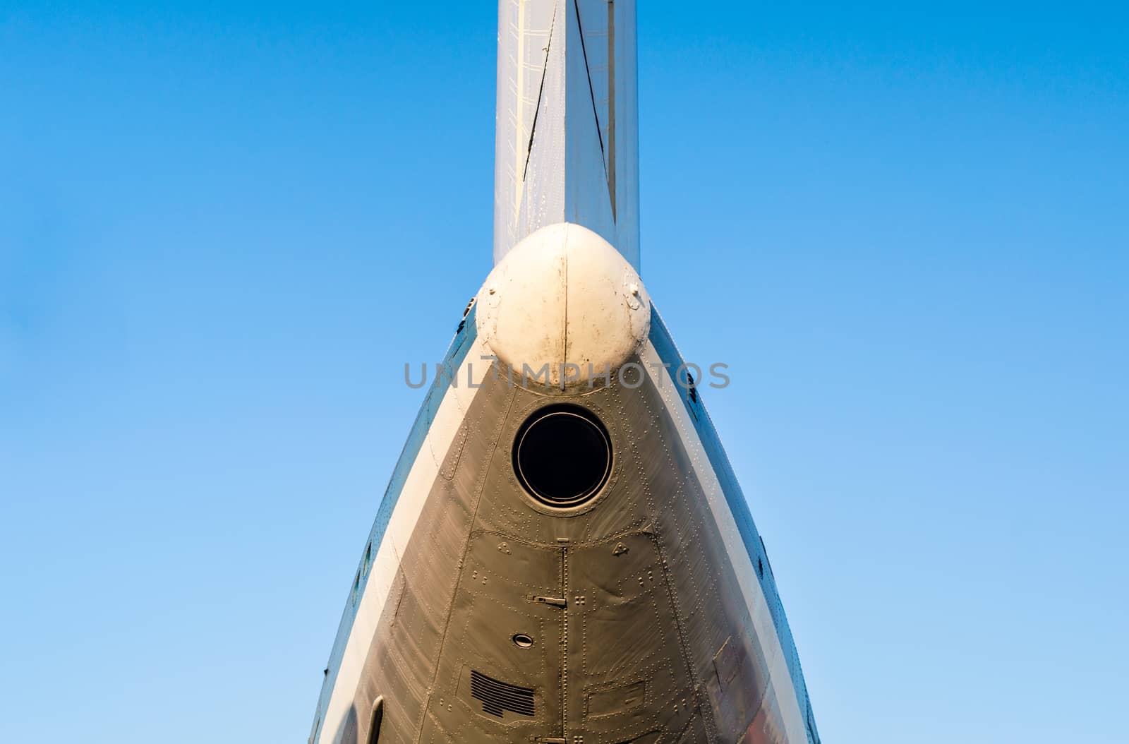 fragment of the plane of an old airliner against a blue sky isolated