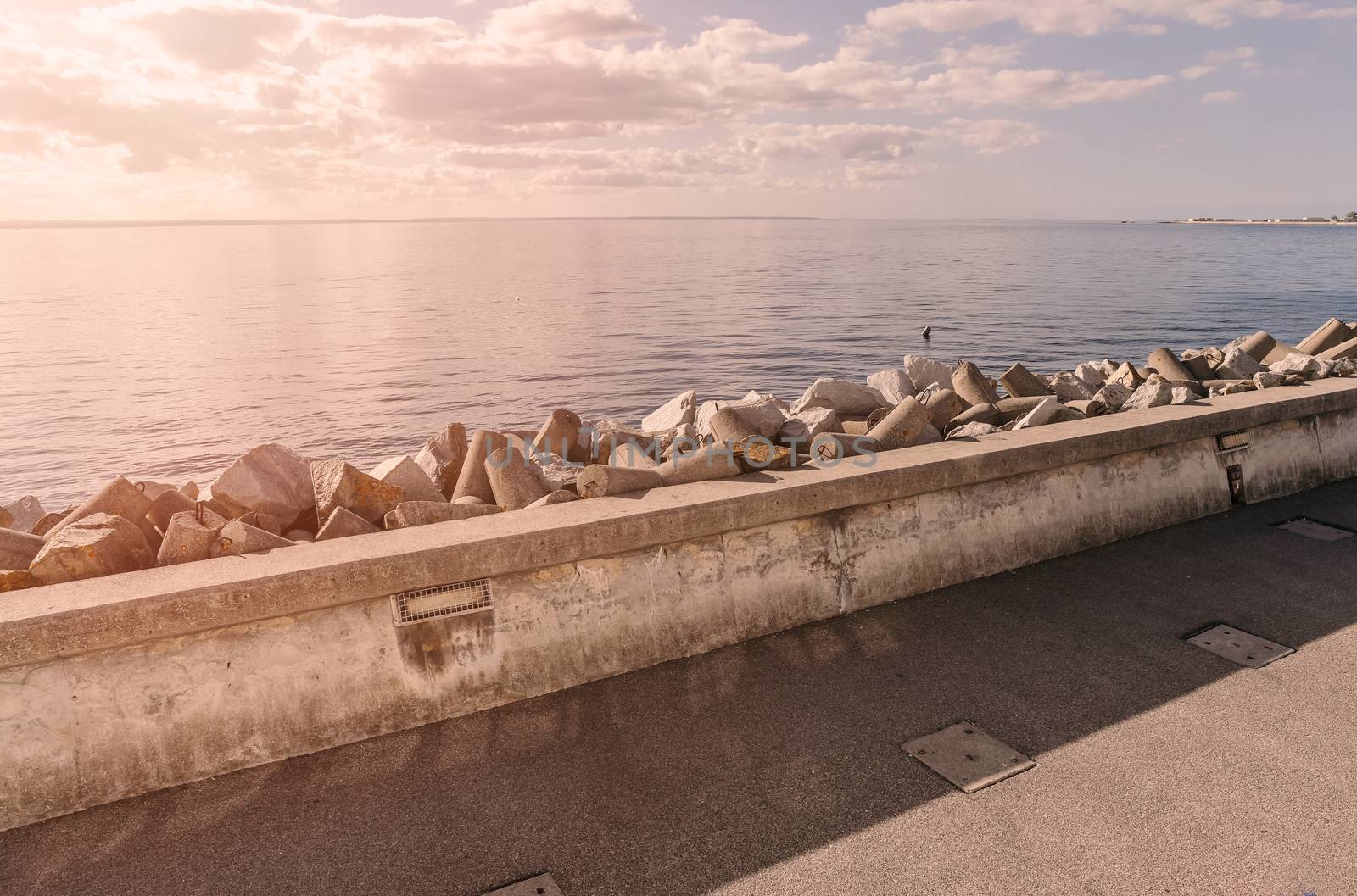 Coastline with concrete wave breaker in the shape of rocks