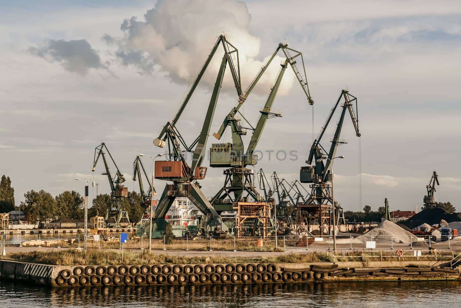 Big container cranes in the port of Gdansk, Poland in different scenery