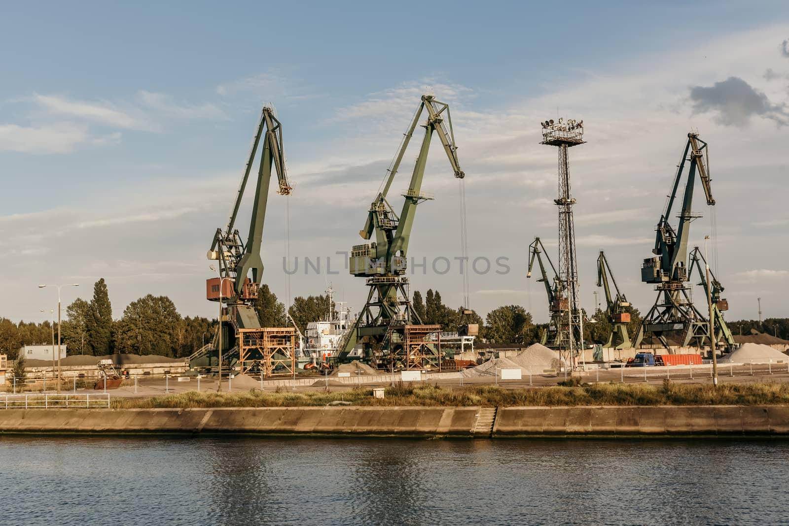 Big container cranes in the port of Gdansk, Poland in different scenery