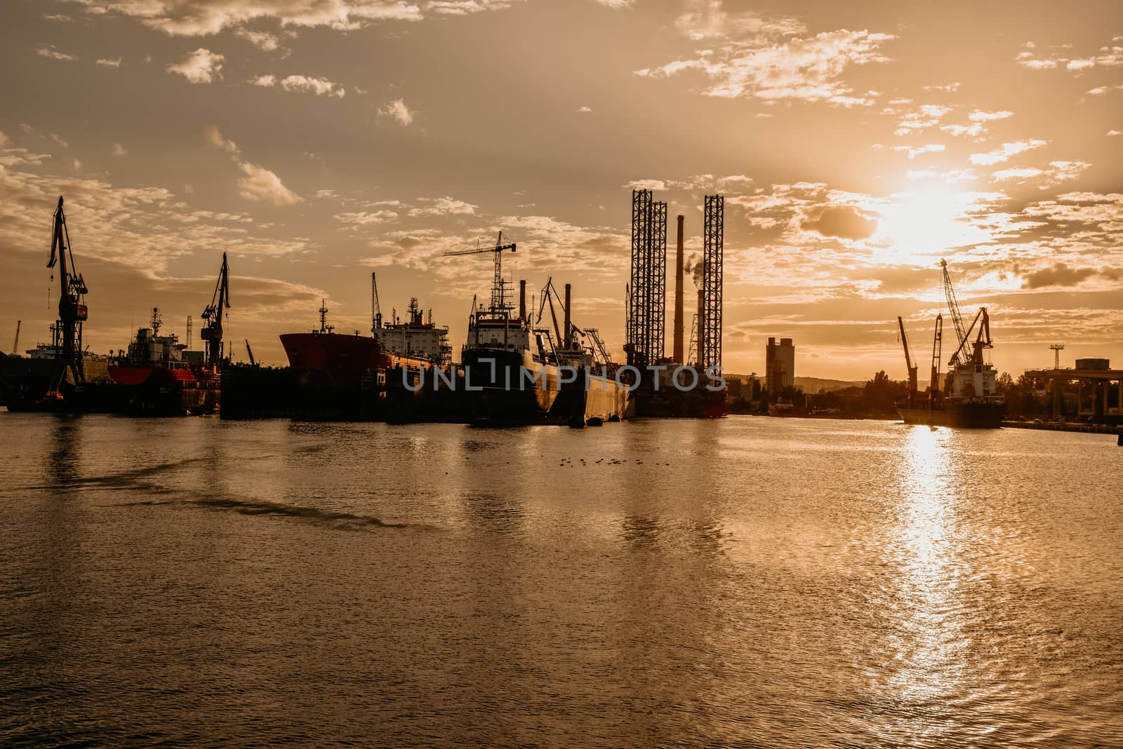 Big container cranes in the port of Gdansk, Poland in different scenery