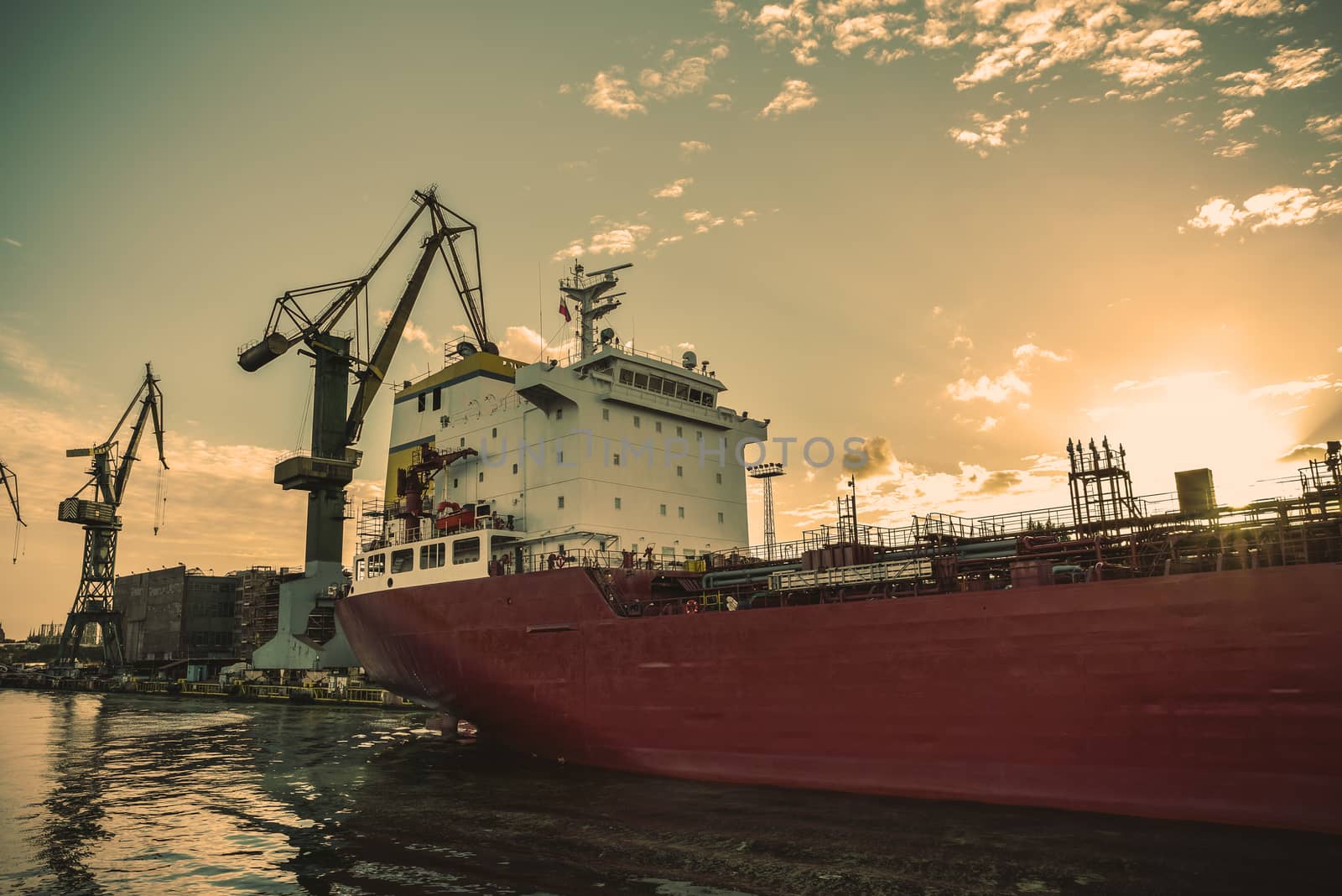 Big container cranes in the port of Gdansk, Poland in different scenery