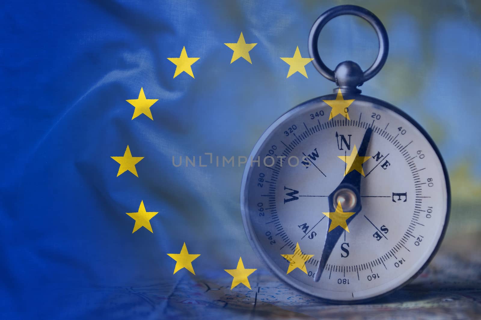 European Union flag wavy surface and classic white compass in the background. Full frame wallpaper or background concept