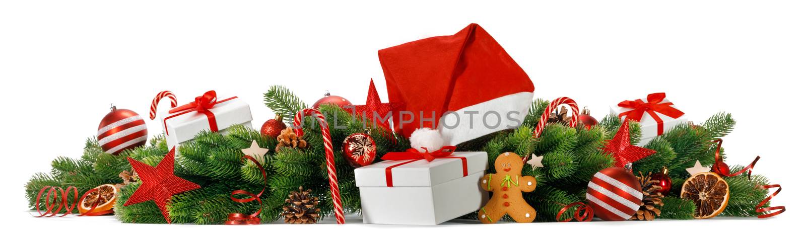 Merry Christmas greeting card idea with green fir tree, gifts, red Santa Claus hat, decor of balls and baubles, pine cones, candy canes and gingerbread cookies studio isolated on white background
