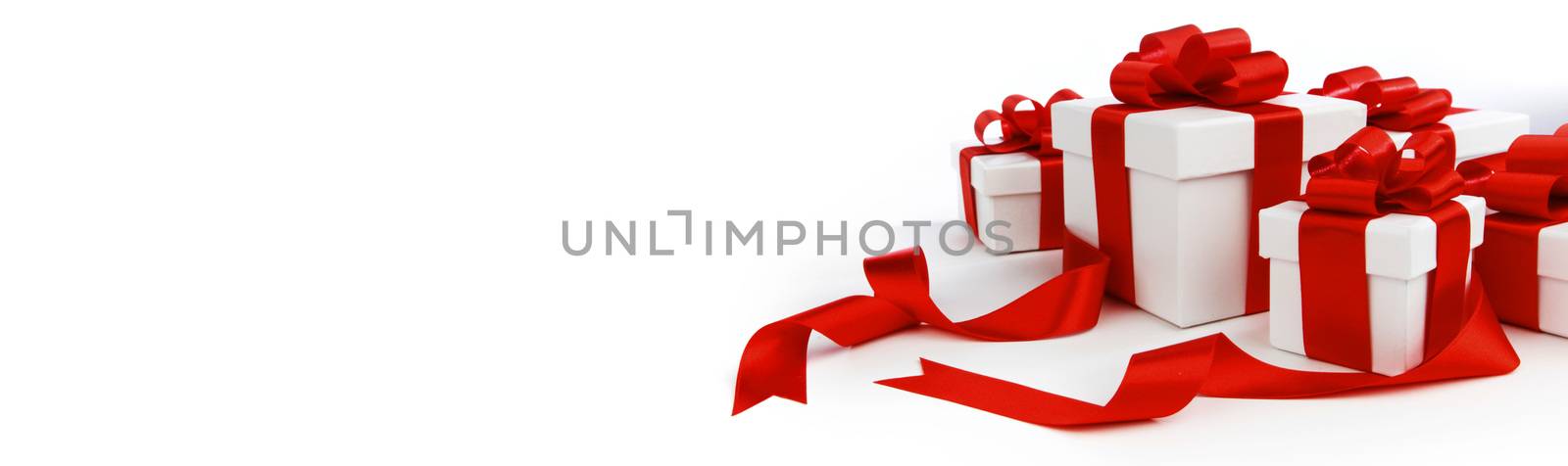 Group of holiday Gift boxes with red bows isolated on white background