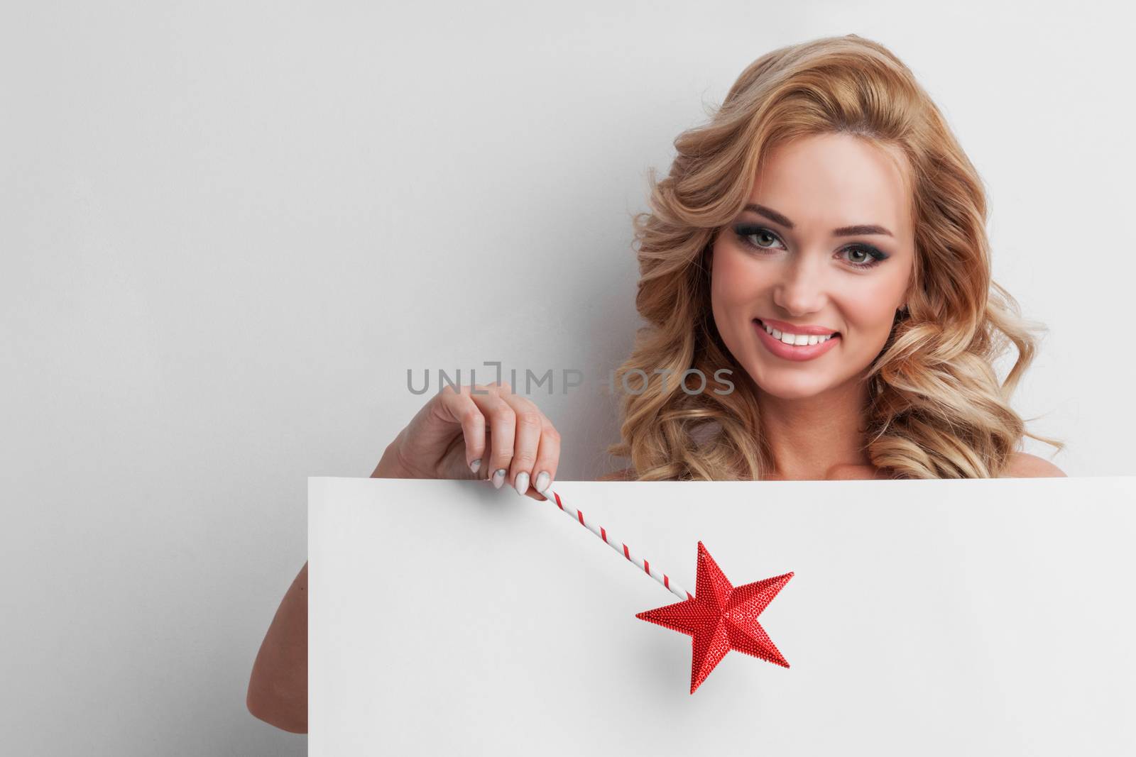 Fairy woman with magic wand with star pointing at white background with copy space for text