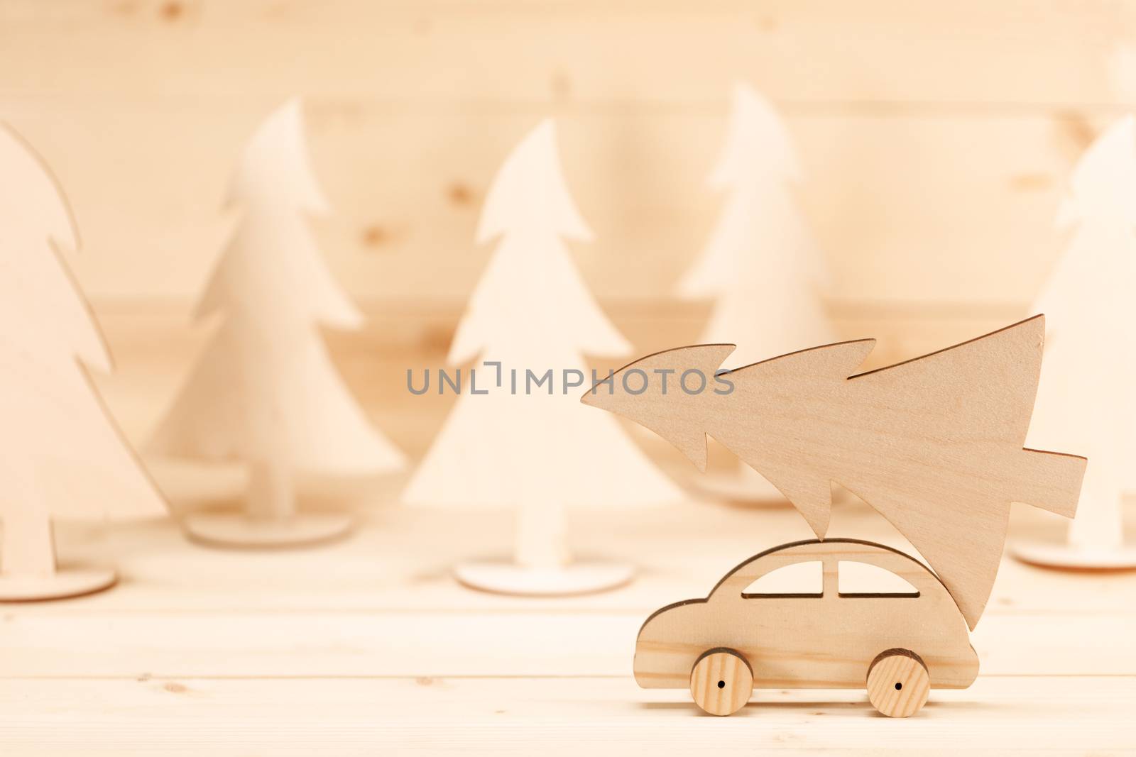 Christmas background. Toy handmade wooden car with christmas tree. Merry Christmas and Happy New Year background