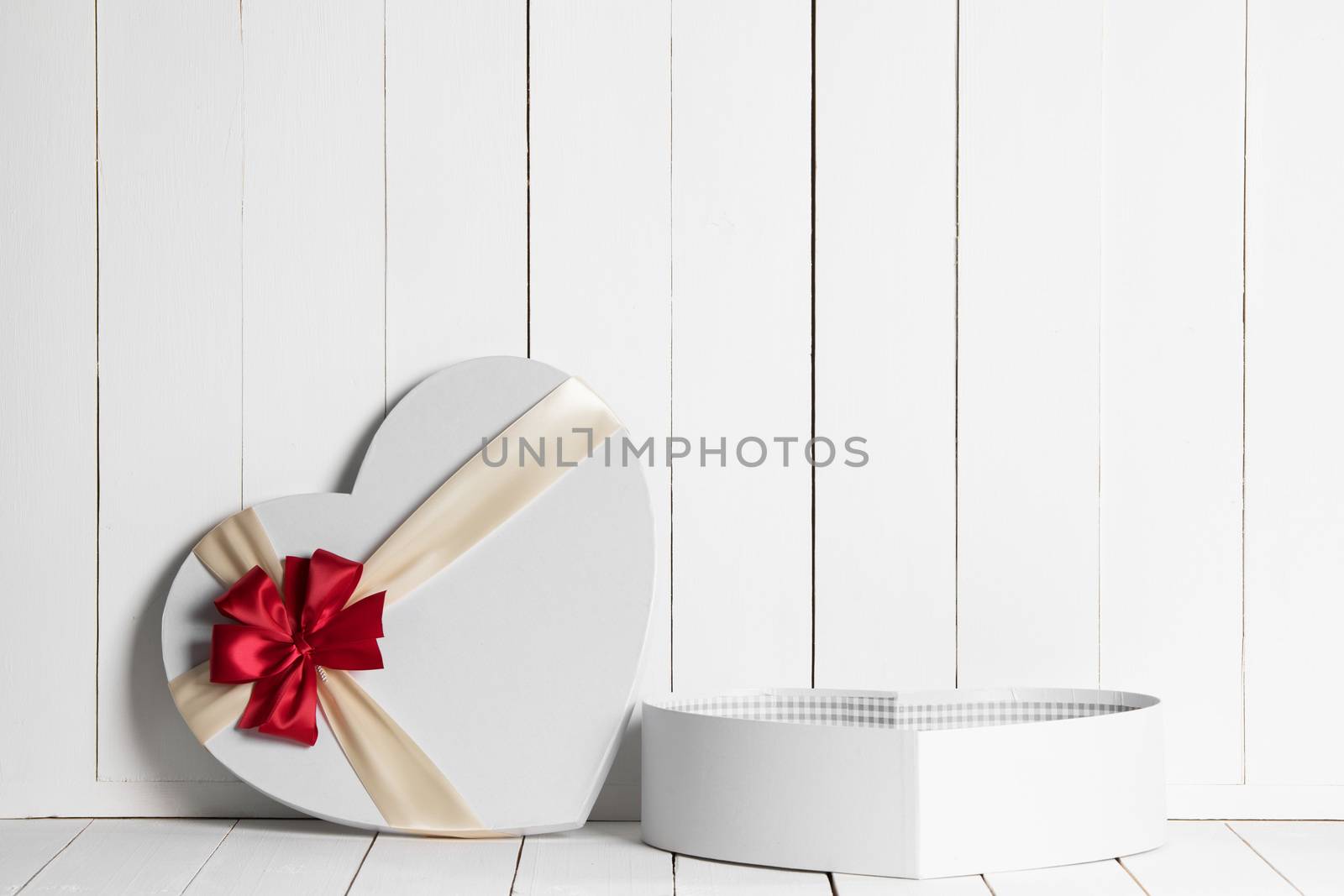 Heart shaped Valentines Day gift box on white wooden background