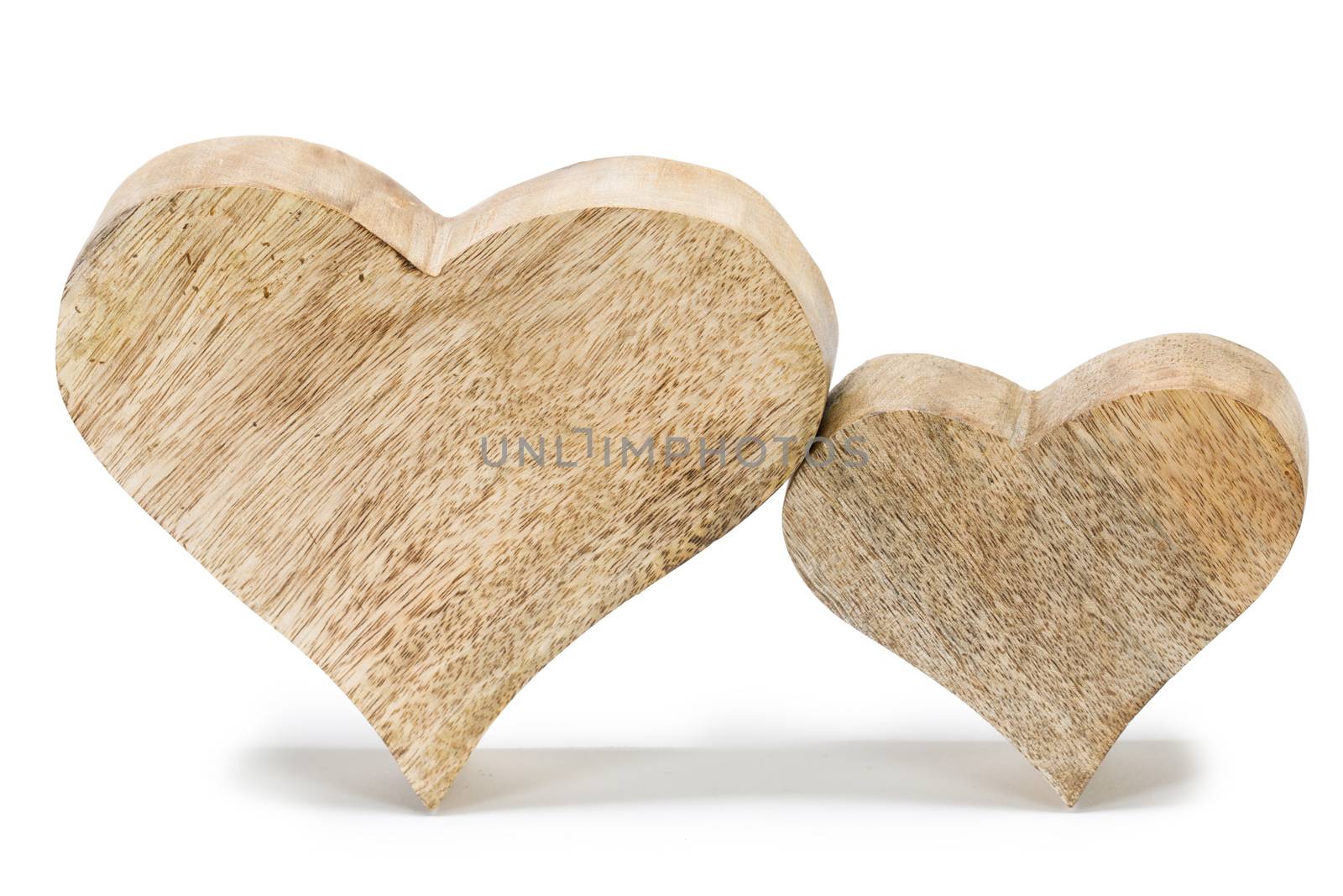 Two handmade wooden carved hearts isolated on white background couple relationship Valentine day concept