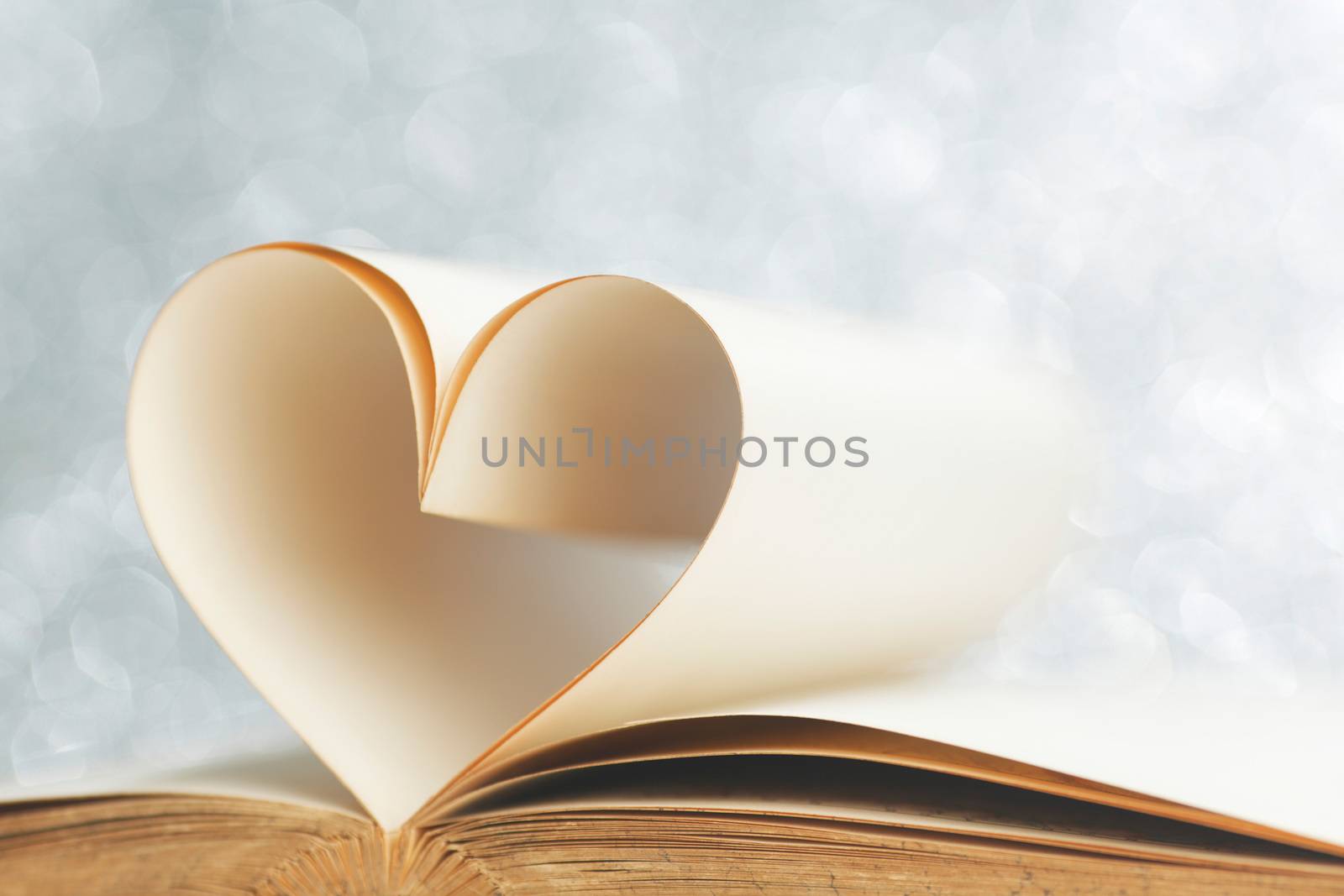 Book with opened pages and shape of heart love reading concept