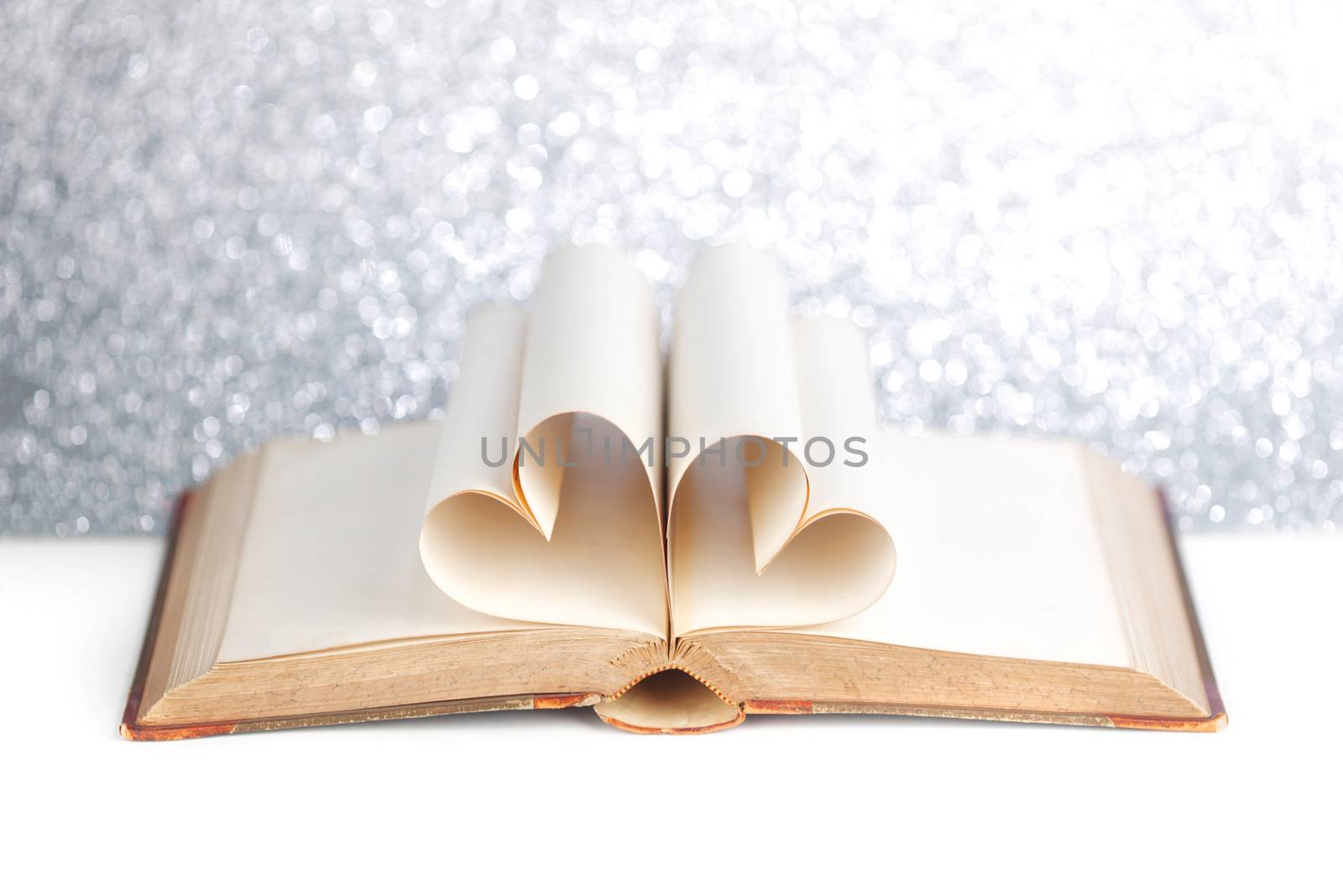 Book with opened pages and shape of heart love reading concept