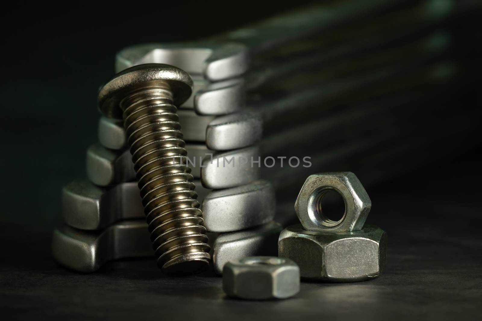 Bolt nuts and wrench on cement floor in darkness. by SaitanSainam