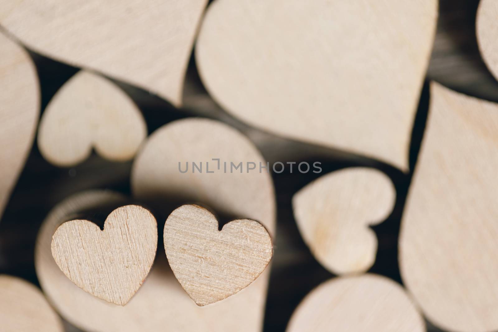 Many wooden colorless hearts background