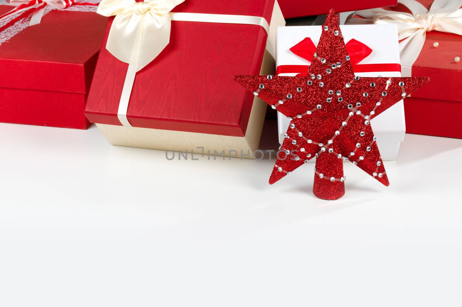 Decorated Christmas gifts and star isolated on white background