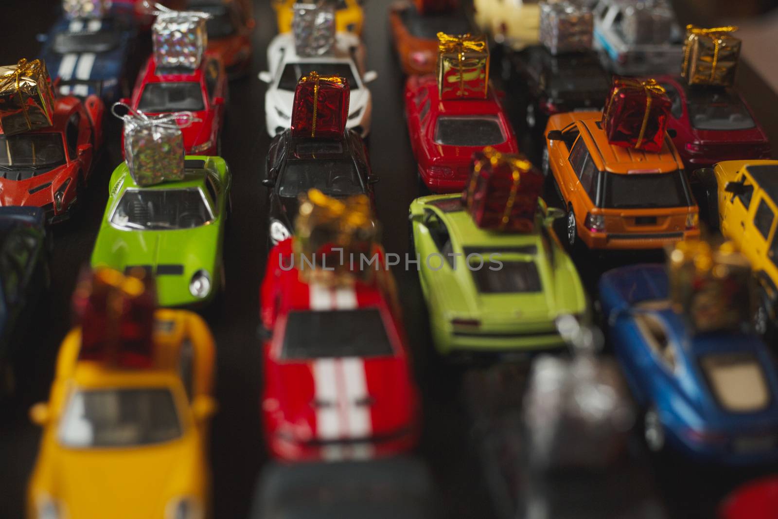 Traffic jam of toy cars carrying holiday gifts or black friday sale purchase