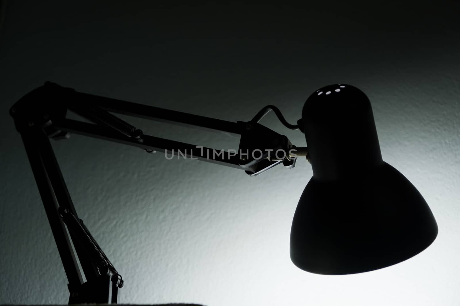 Silhouette of a table lamp on the background of a window in the morning at dawn, work until morning, work at night. by peerapixs