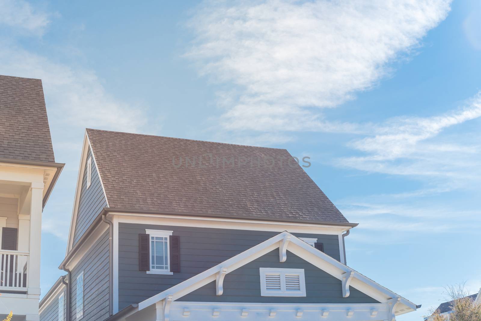 Typical cottage style homes in suburbs Dallas, Texas with wood siding, shingle tiles, covered porch. Cladding layer thermal insulation, weather resistance, improve vintage house appearance