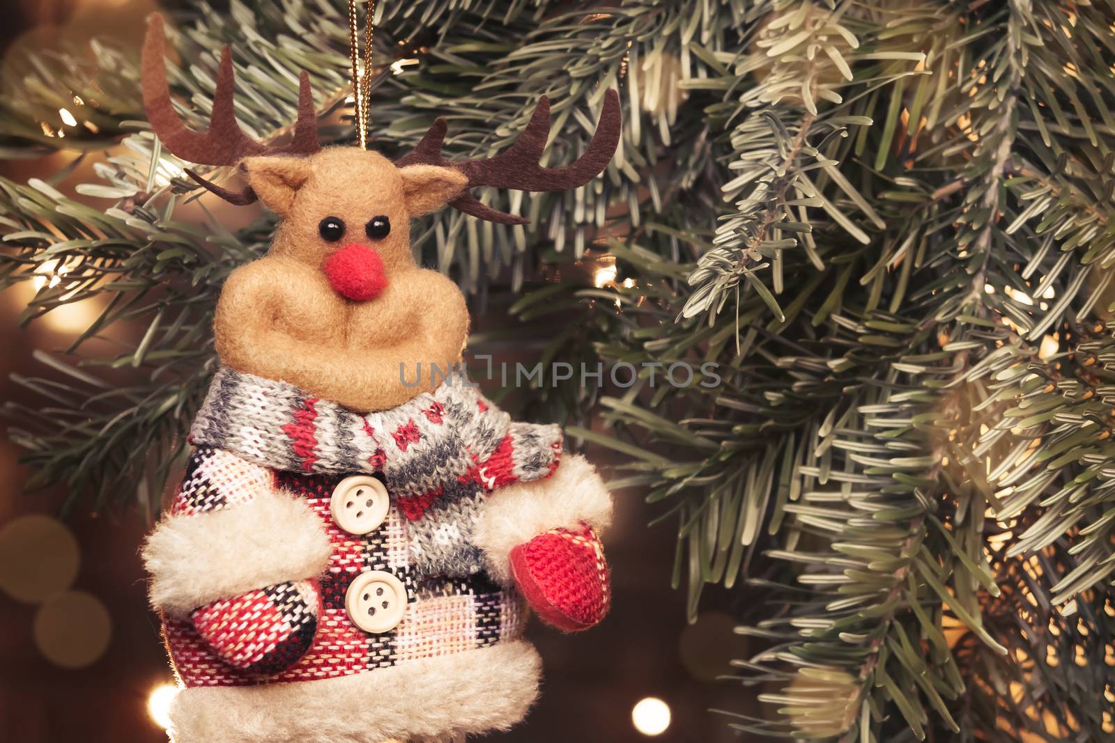 Toy deer on a Christmas tree on the background of Christmas lights, place for text, copy space by galsand