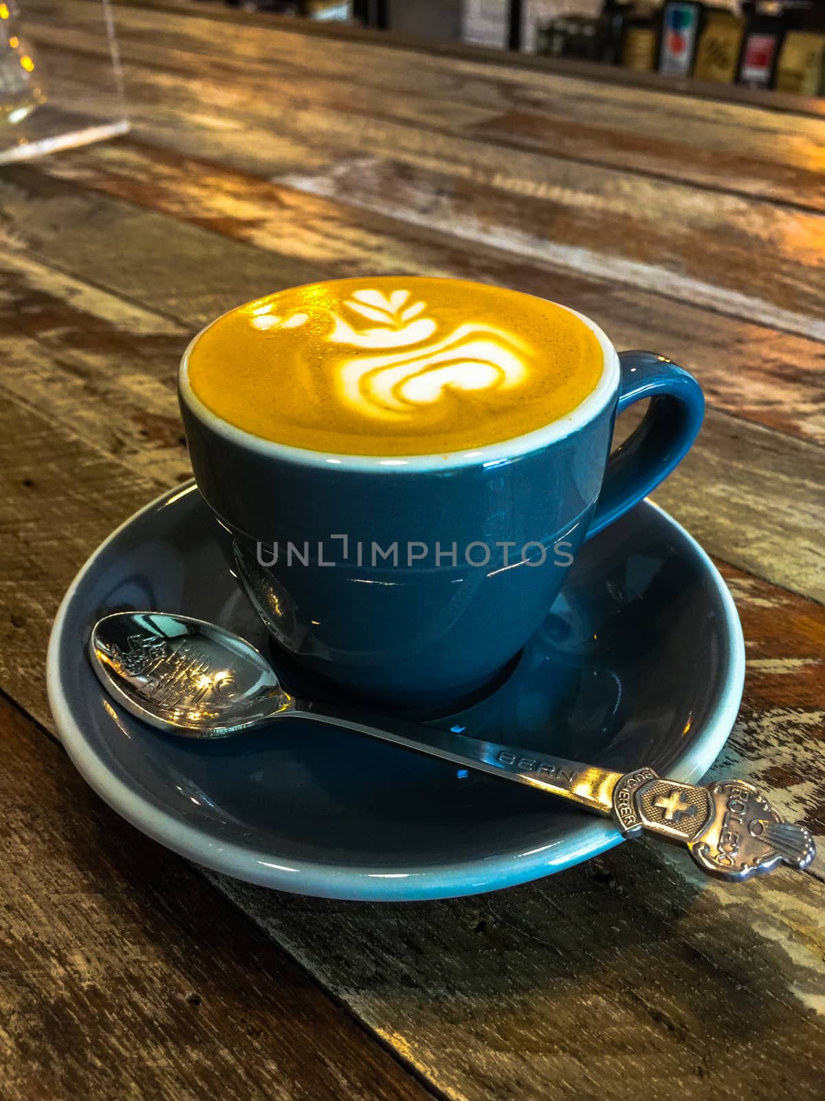 Coffee Time peple in cafe. Coffee black cup with milk and heart shape. Hot mocha coffee or capuchino in the black cup with heart pattern leather on the table. Beverage, full. Thai coffee.