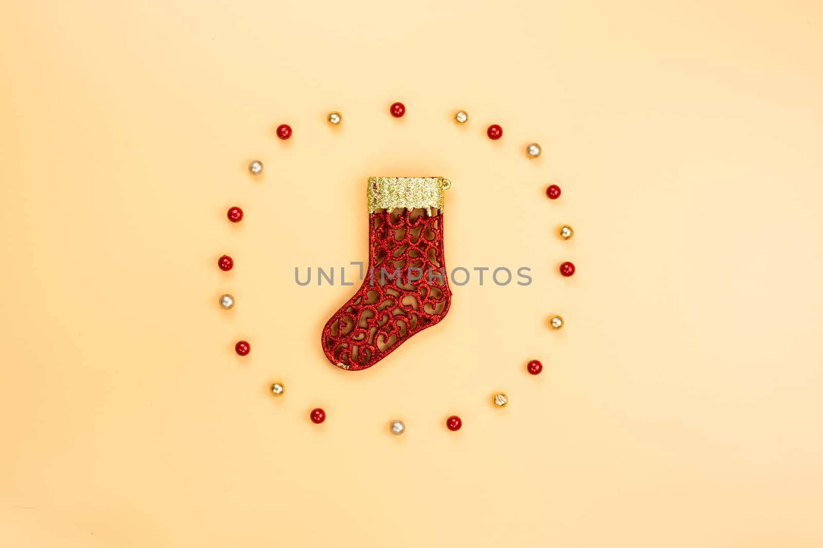 Christmas holidays composition, top view of red and gold Christmas decorations on yellow background with copy space for text. Flat lay, winter, postcard template, new year concept.