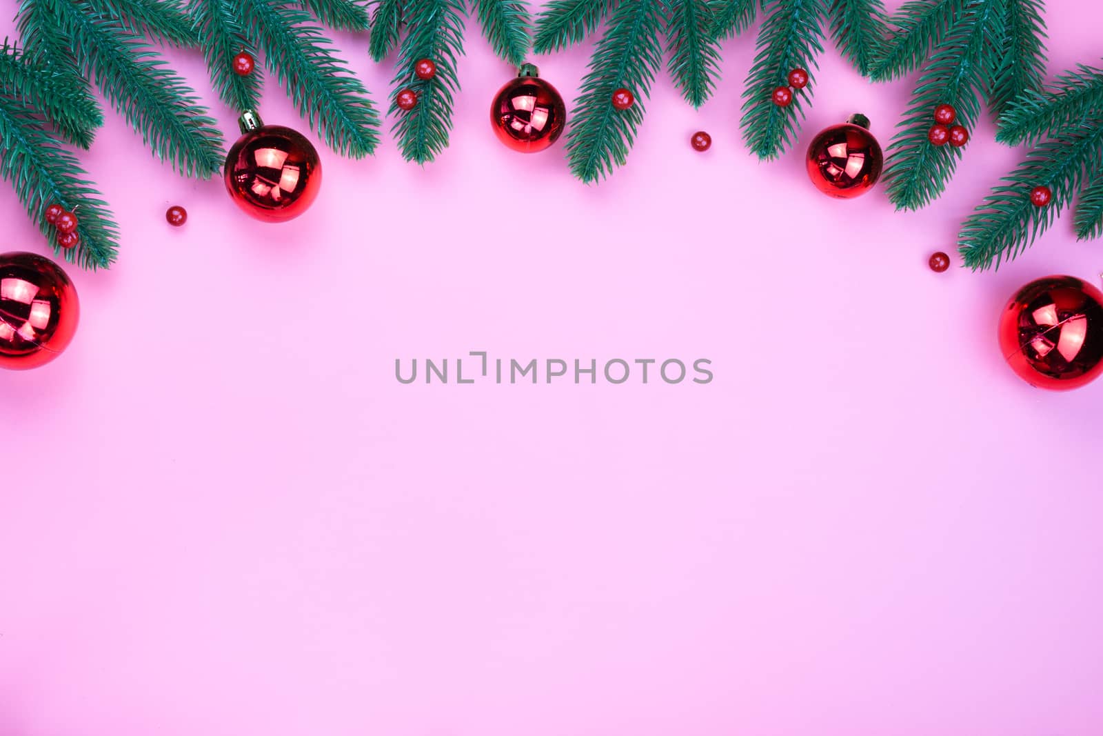 Christmas holidays composition, top view of red Christmas decorations on pink background with copy space for text. Flat lay, winter, postcard template, new year concept.