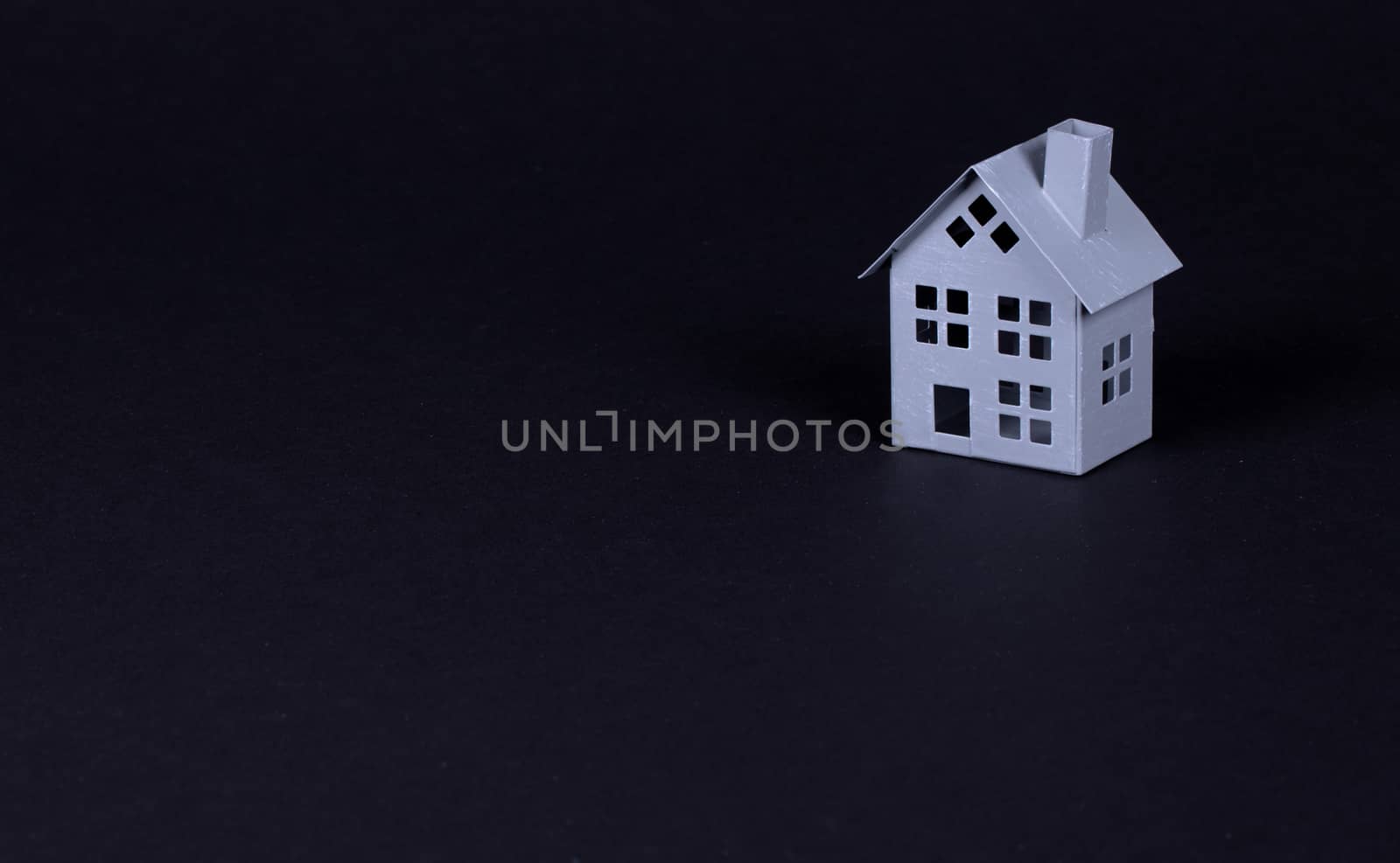 Estate concept, metal house on isolated on black background - Idea for real estate concept, personal property and family house