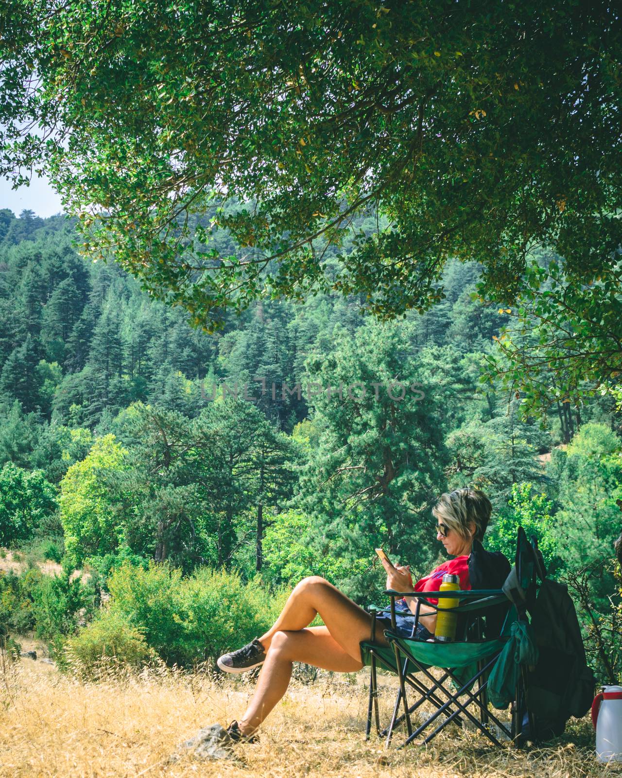 Browsing through her mobile phone.