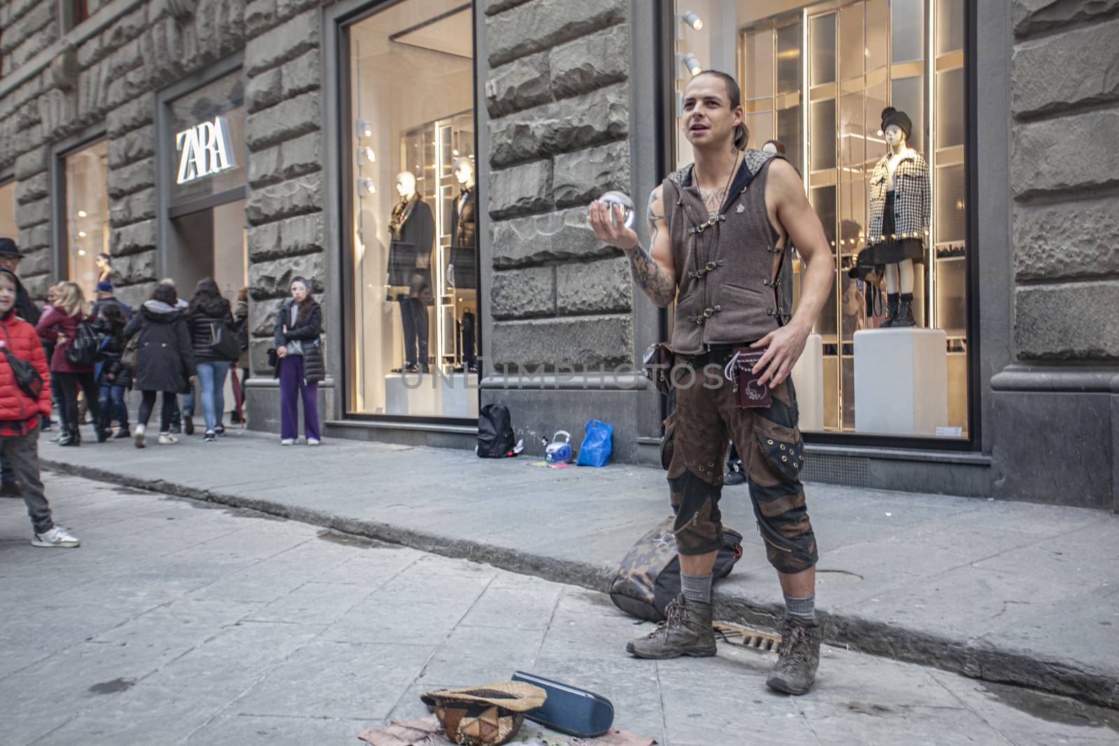 Street artist performs in one of the main streets of Florence