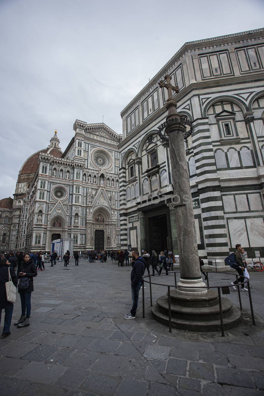 Detail of the Piazza del Duomo in Florence with tourists visiting it on a cloudy day with the light that enhances the colors