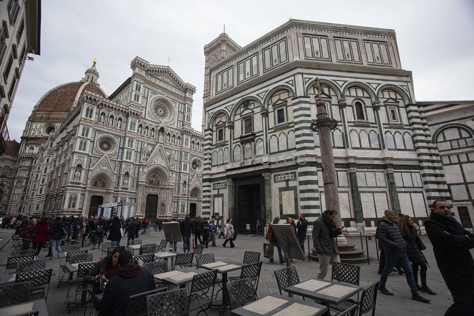 Detail of the Piazza del Duomo in Florence with tourists visiting it on a cloudy day with the light that enhances the colors