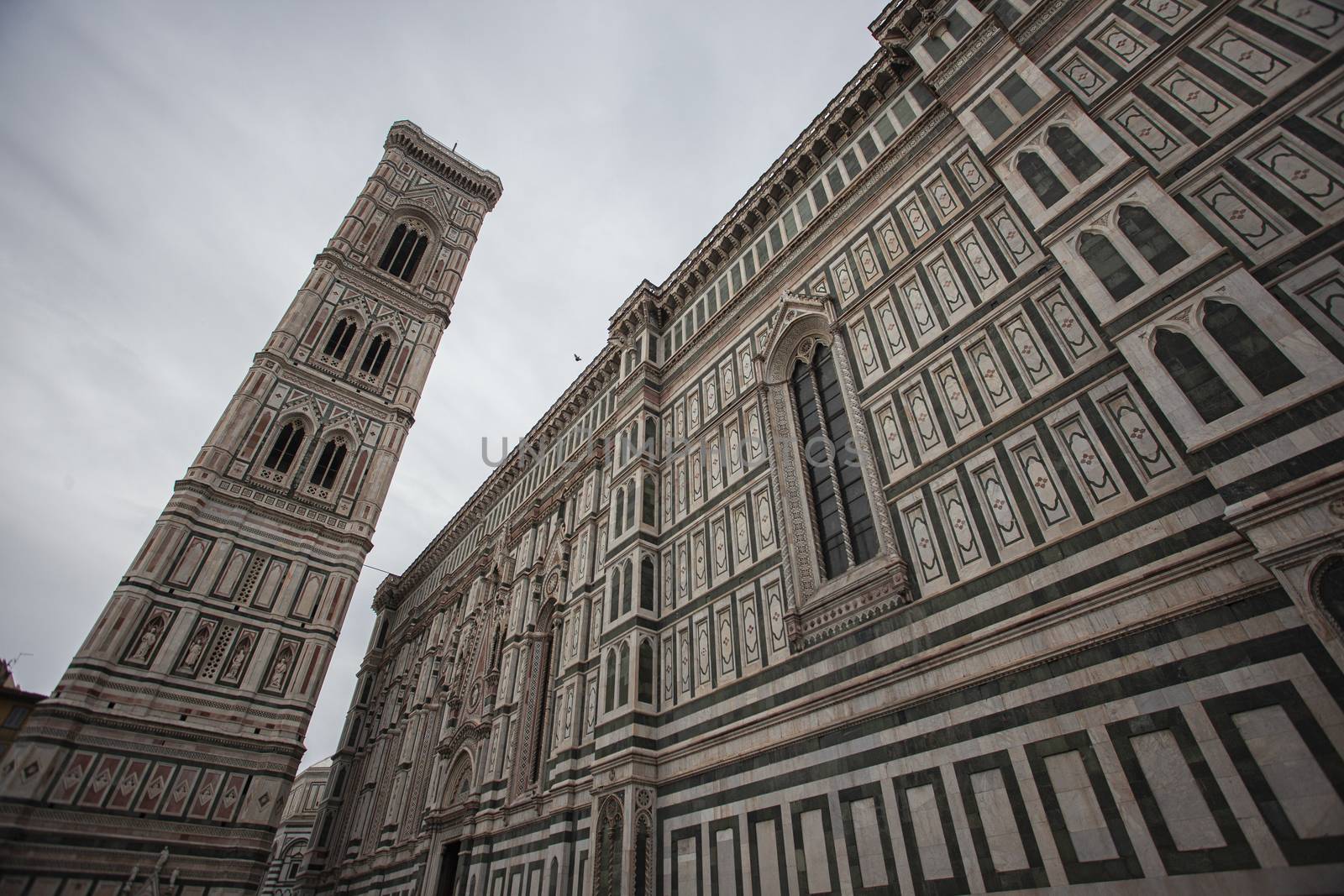 Detail of the Piazza del Duomo in Florence with tourists visiting it on a cloudy day with the light that enhances the colors