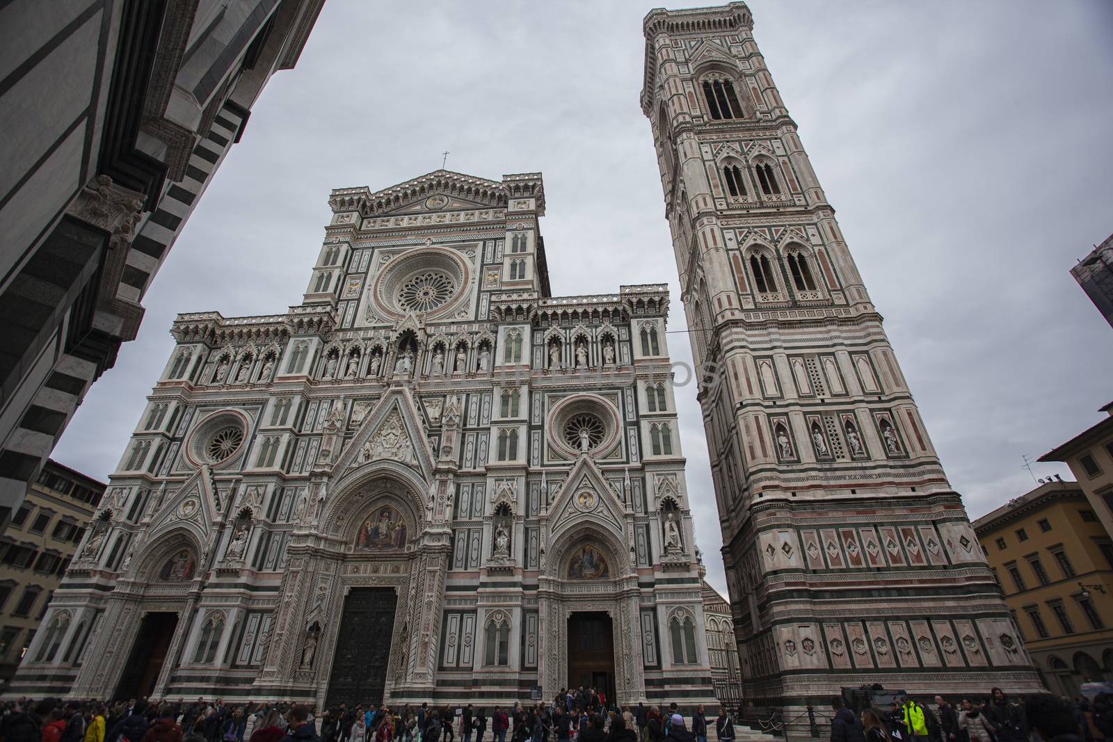 Detail of the Piazza del Duomo in Florence with tourists visiting it on a cloudy day with the light that enhances the colors