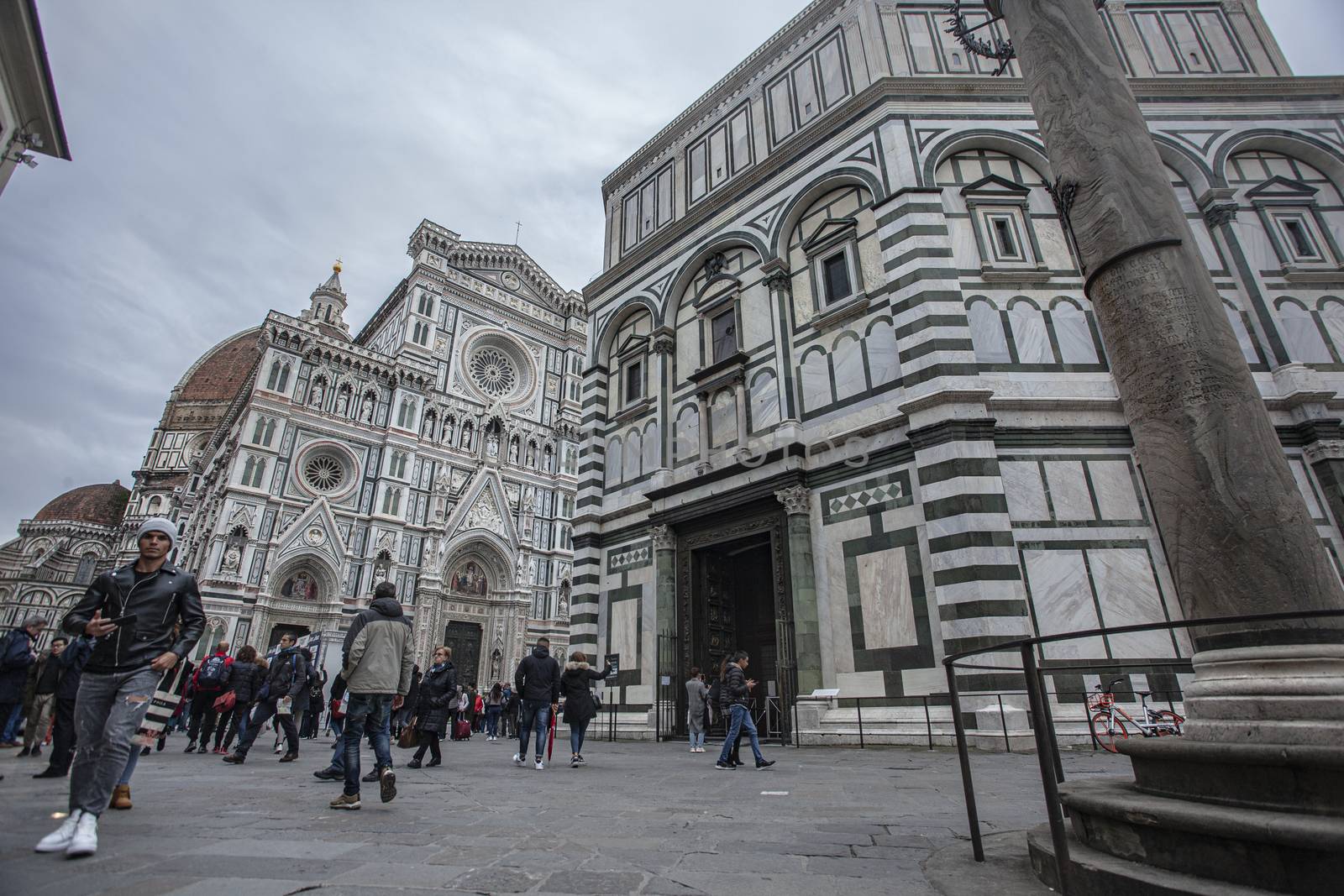 Detail of the Piazza del Duomo in Florence with tourists visiting it on a cloudy day with the light that enhances the colors