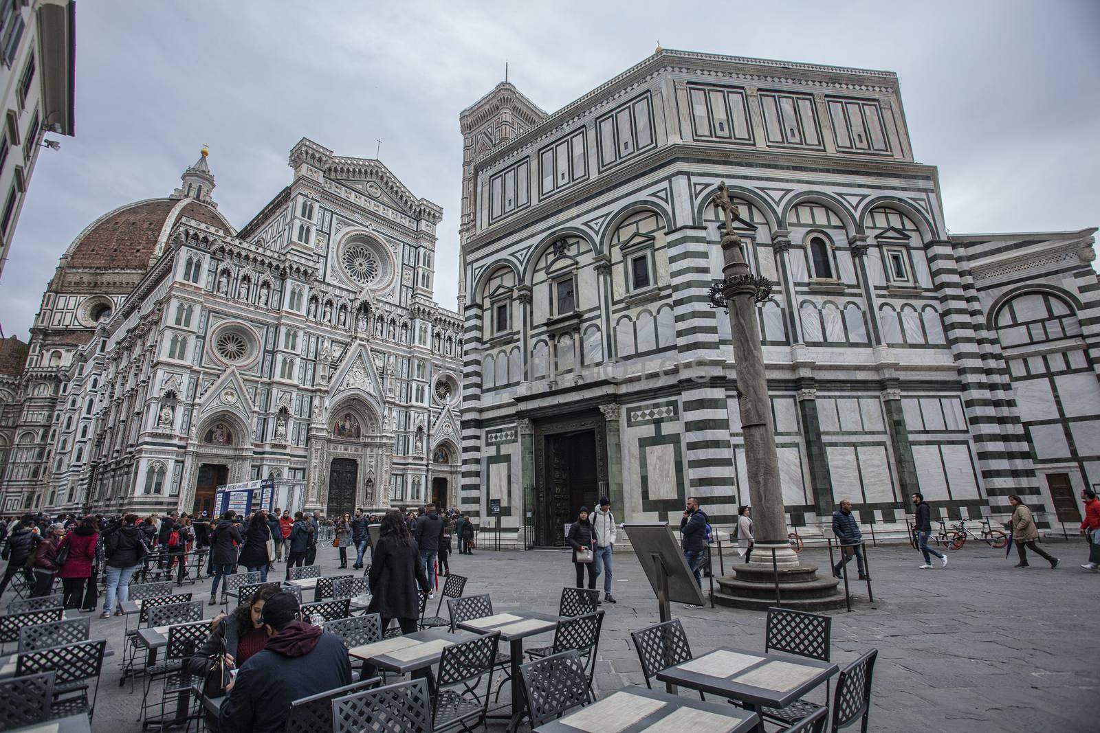 Detail of the Piazza del Duomo in Florence with tourists visiting it on a cloudy day with the light that enhances the colors