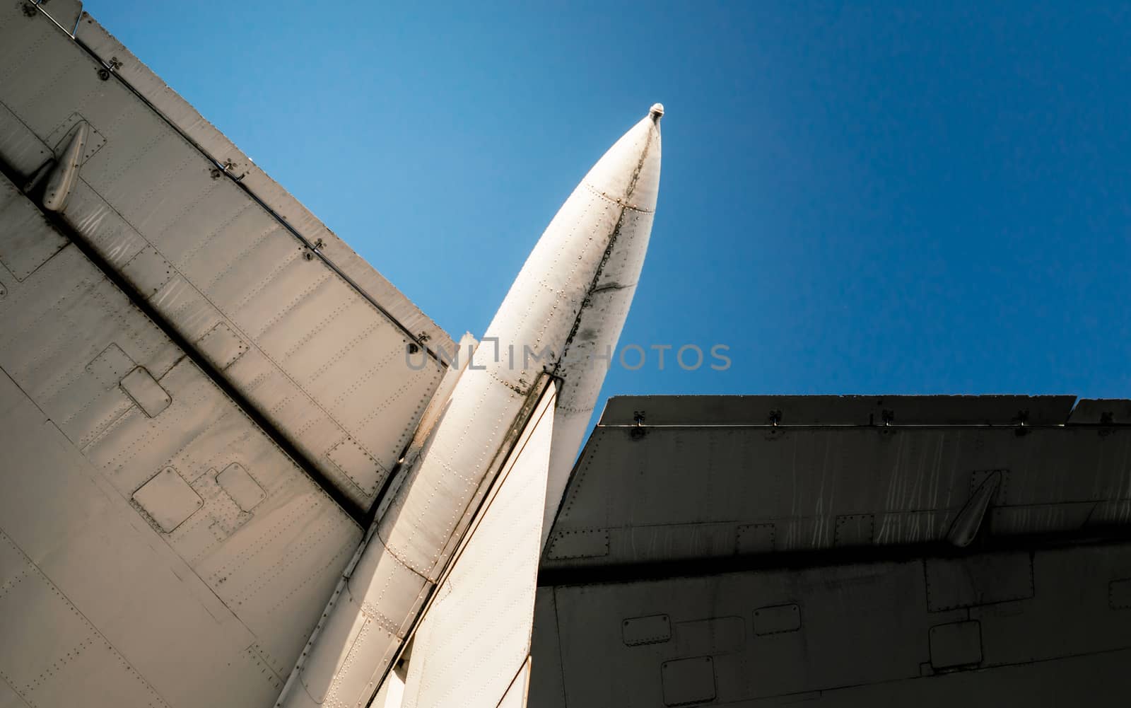 background wings of a large soviet airliner against a blue sky isolated close up
