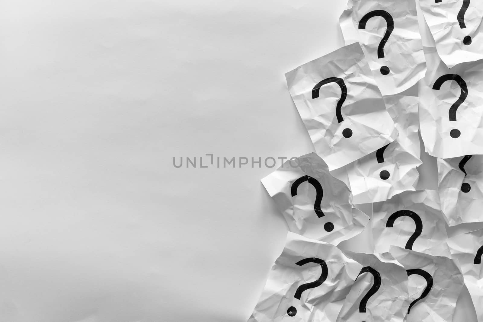 Border of crumpled question marks on cards over a white background with copy space in a conceptual image