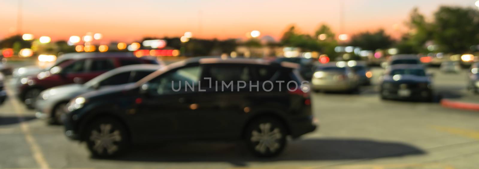 Panoramic blurry background outdoor parking lots of shopping mall in Houston, Texas at sunset by trongnguyen