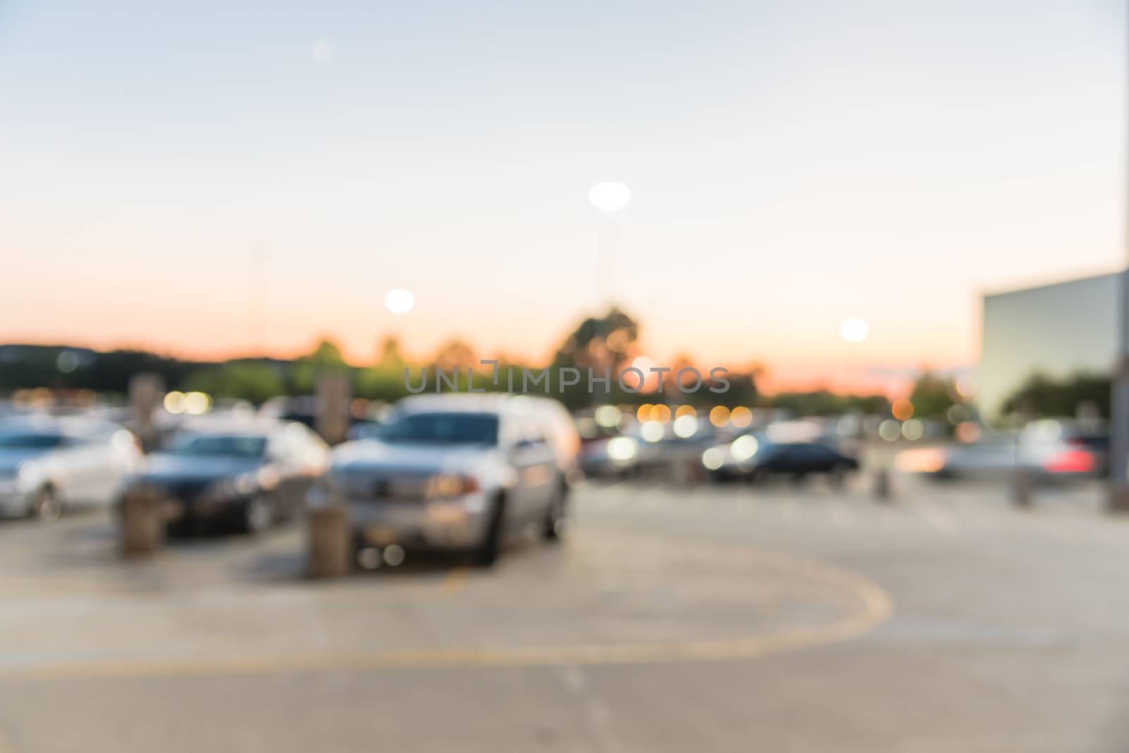 Blurry background exterior of retail stores of shopping mall in Houston, Texas at sunset by trongnguyen