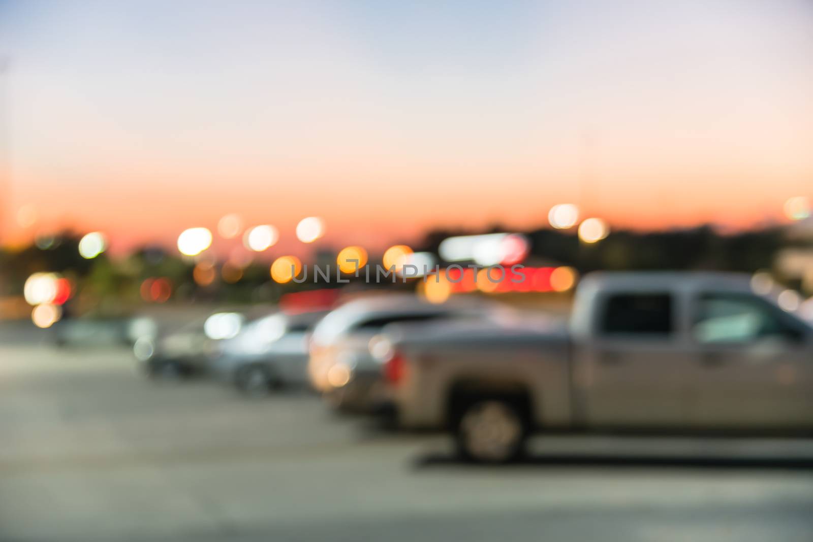 Blurry background outdoor parking lots of shopping mall in Houston, Texas at sunset by trongnguyen