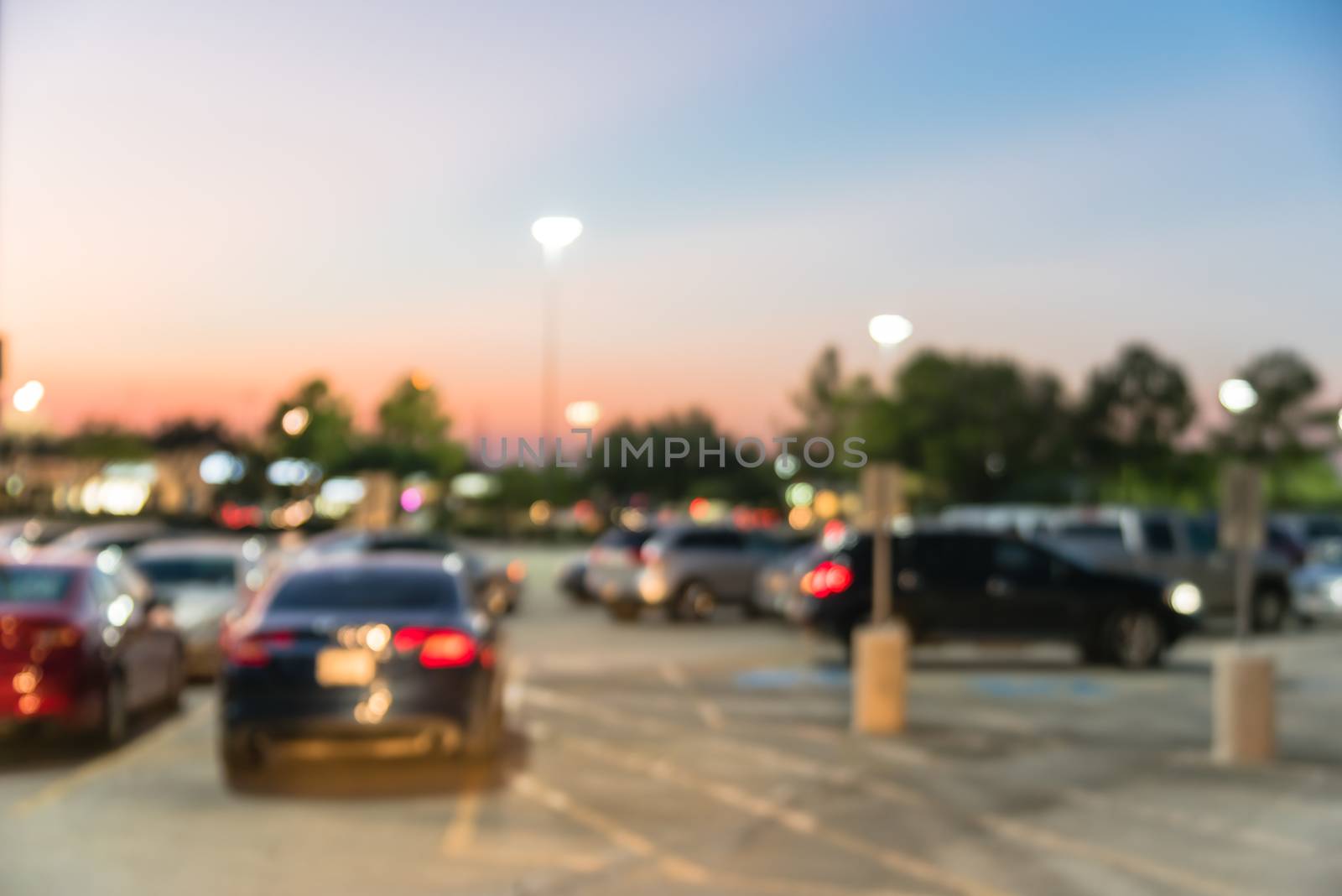 Blurry background exterior of retail stores of shopping mall in Houston, Texas at sunset by trongnguyen