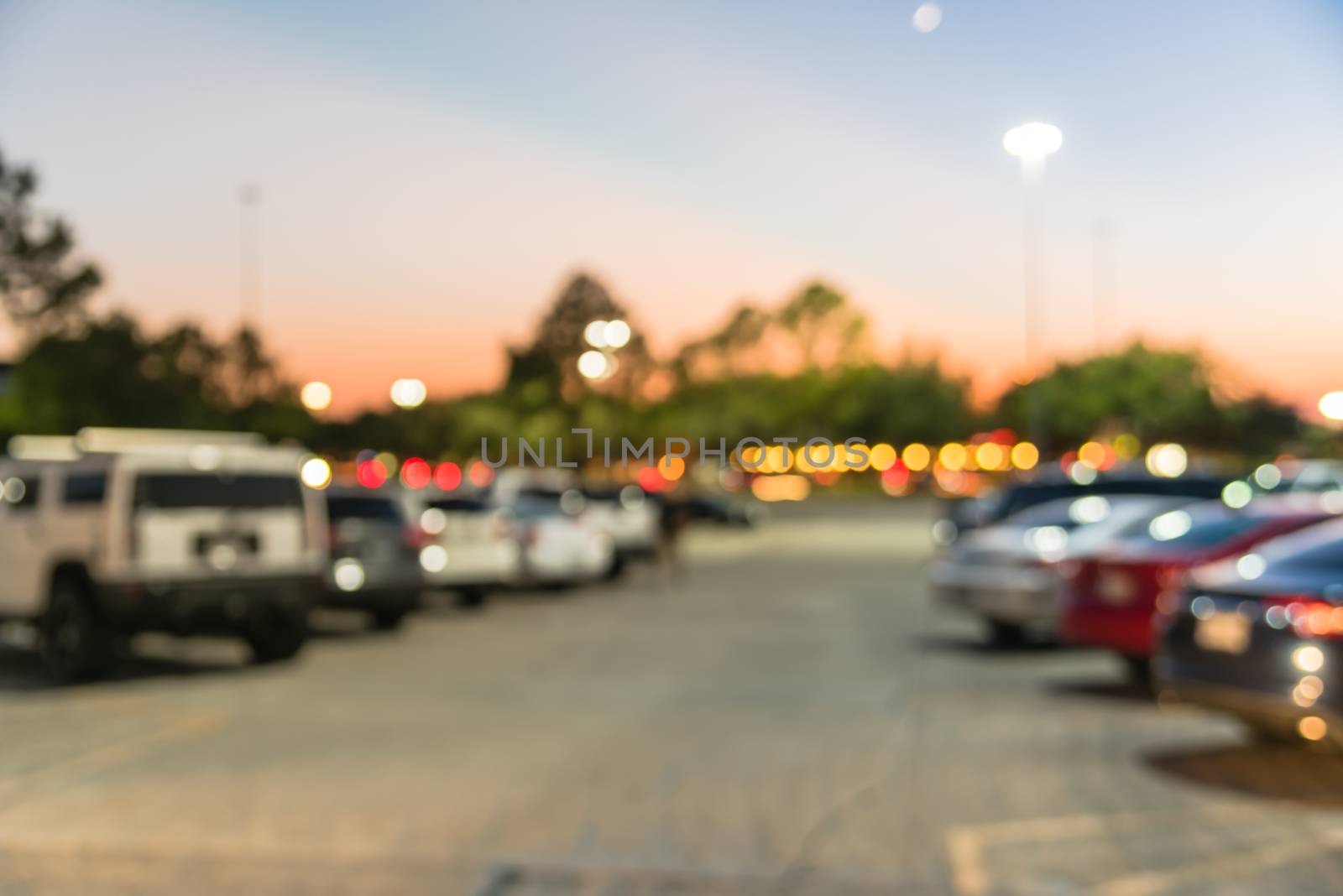 Blurry background outdoor parking lots of shopping mall in Houston, Texas at sunset by trongnguyen