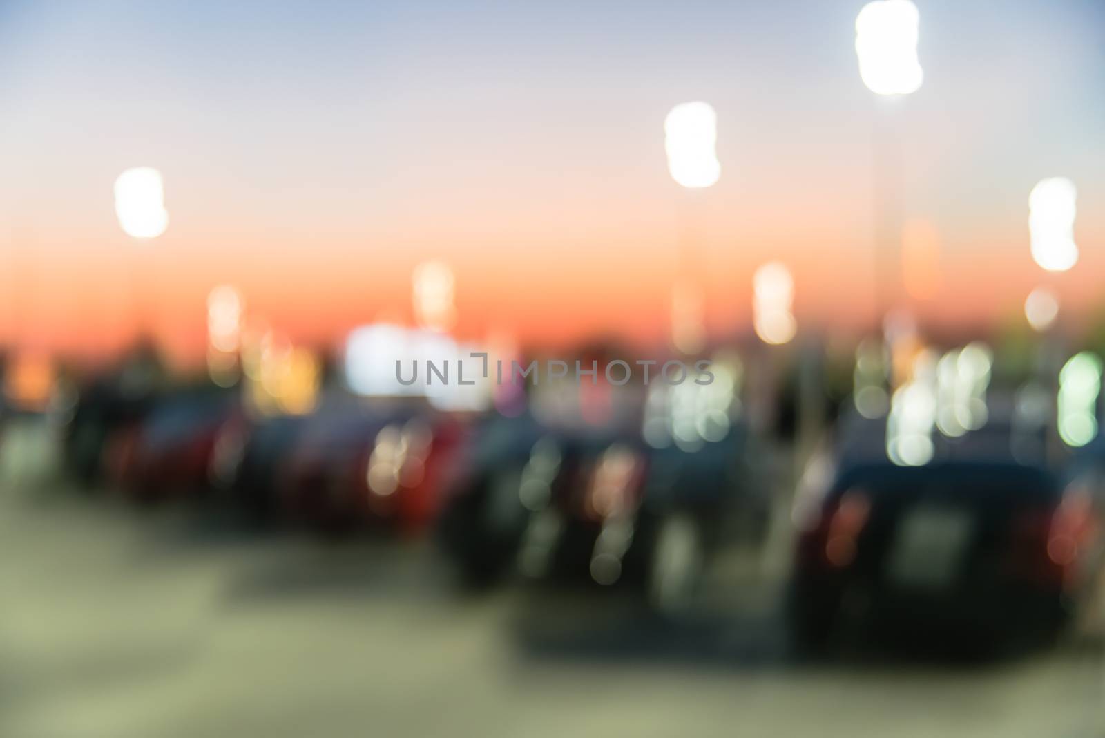 Blurry background outdoor parking lots of shopping mall in Houston, Texas at sunset by trongnguyen