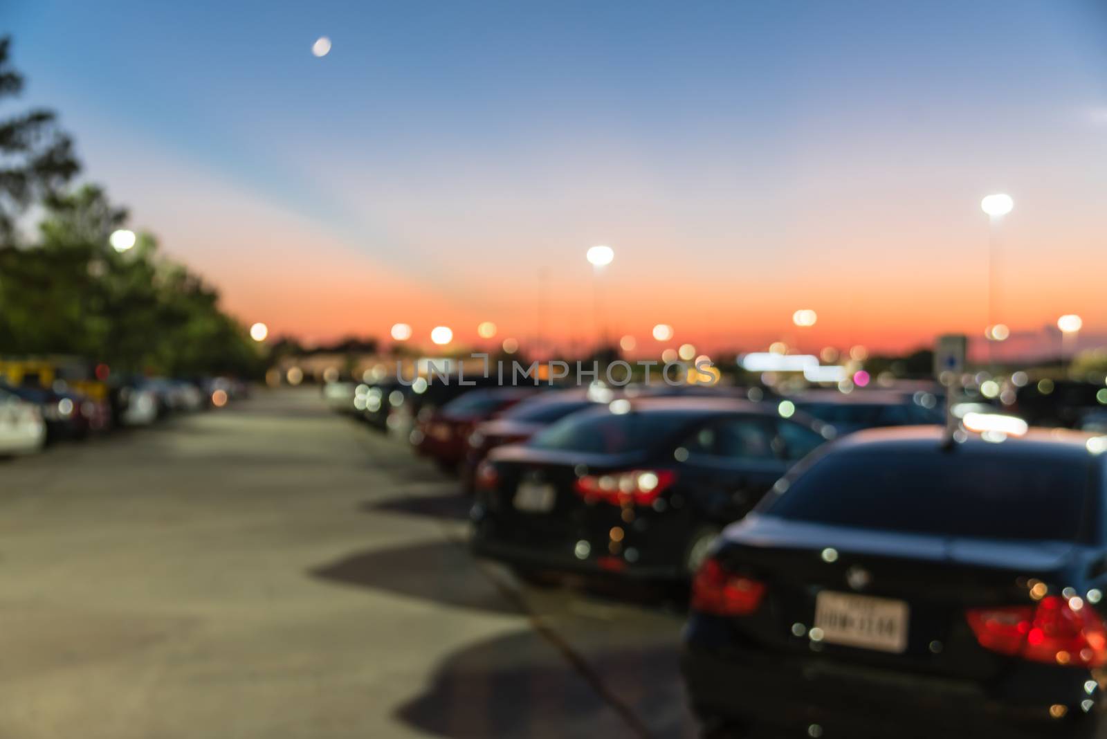 Blurry background outdoor parking lots of shopping mall in Houston, Texas at sunset by trongnguyen