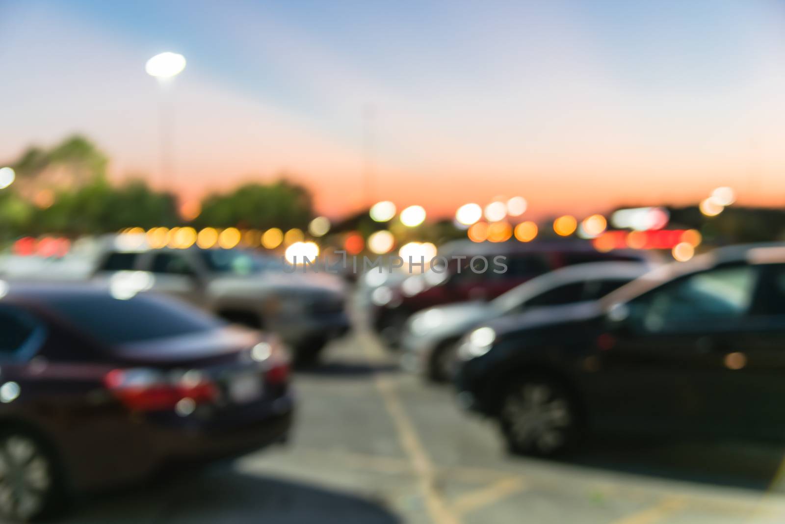 Blurry background outdoor parking lots of shopping mall in Houston, Texas at sunset by trongnguyen