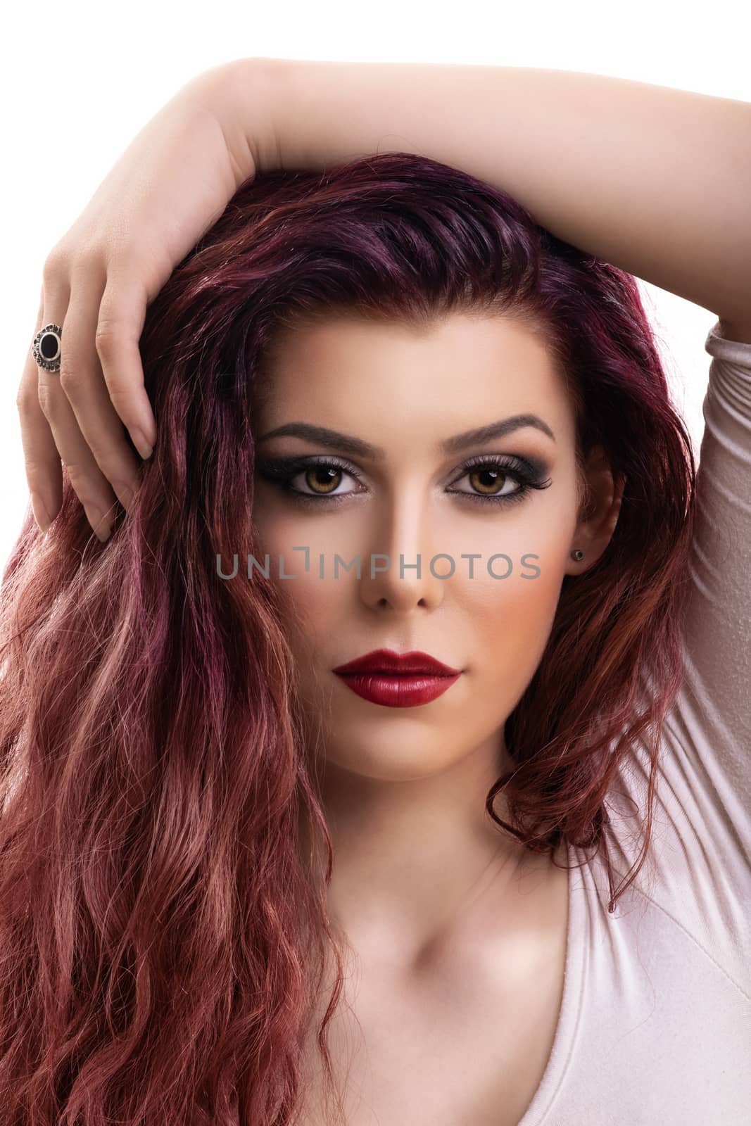Close up profile shot of a beautiful redhead young woman with dark smokey eye makeup and red lipstick, isolated on white background. Female fashion. Beautiful young woman with perfect skin and long hair.
