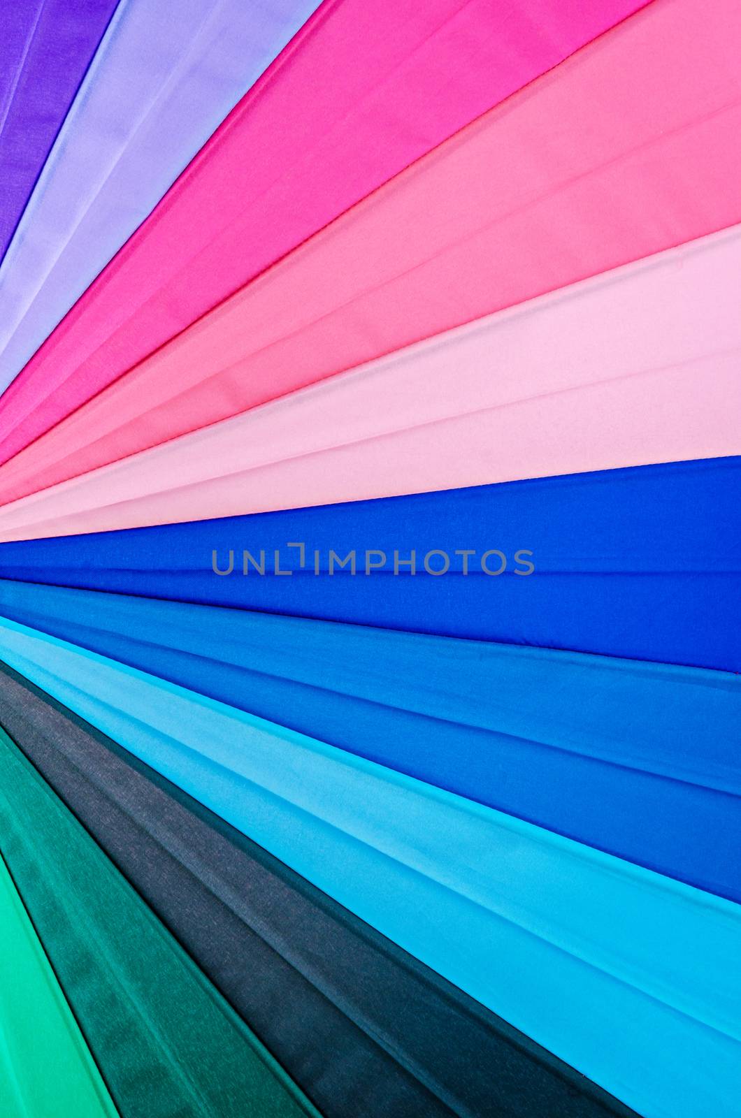 Rainbow spectrum multicolored texture of an umbrella as background.